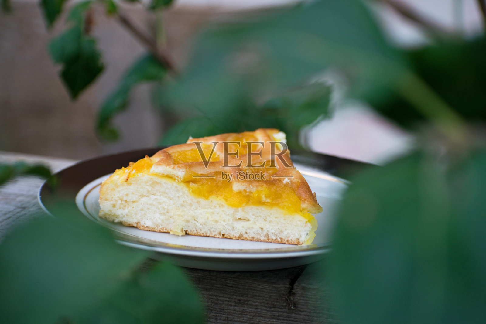 美味的杏仁酱蛋糕放在盘子里。Crostata加橘子酱或桃子酱。自制的蒲公英果酱派甜点。照片摄影图片