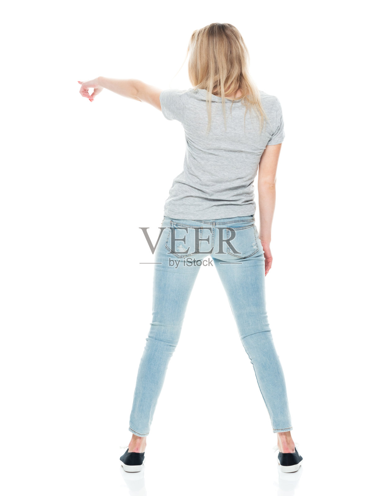 穿着帆布鞋的年轻白人女子站在白色背景前照片摄影图片