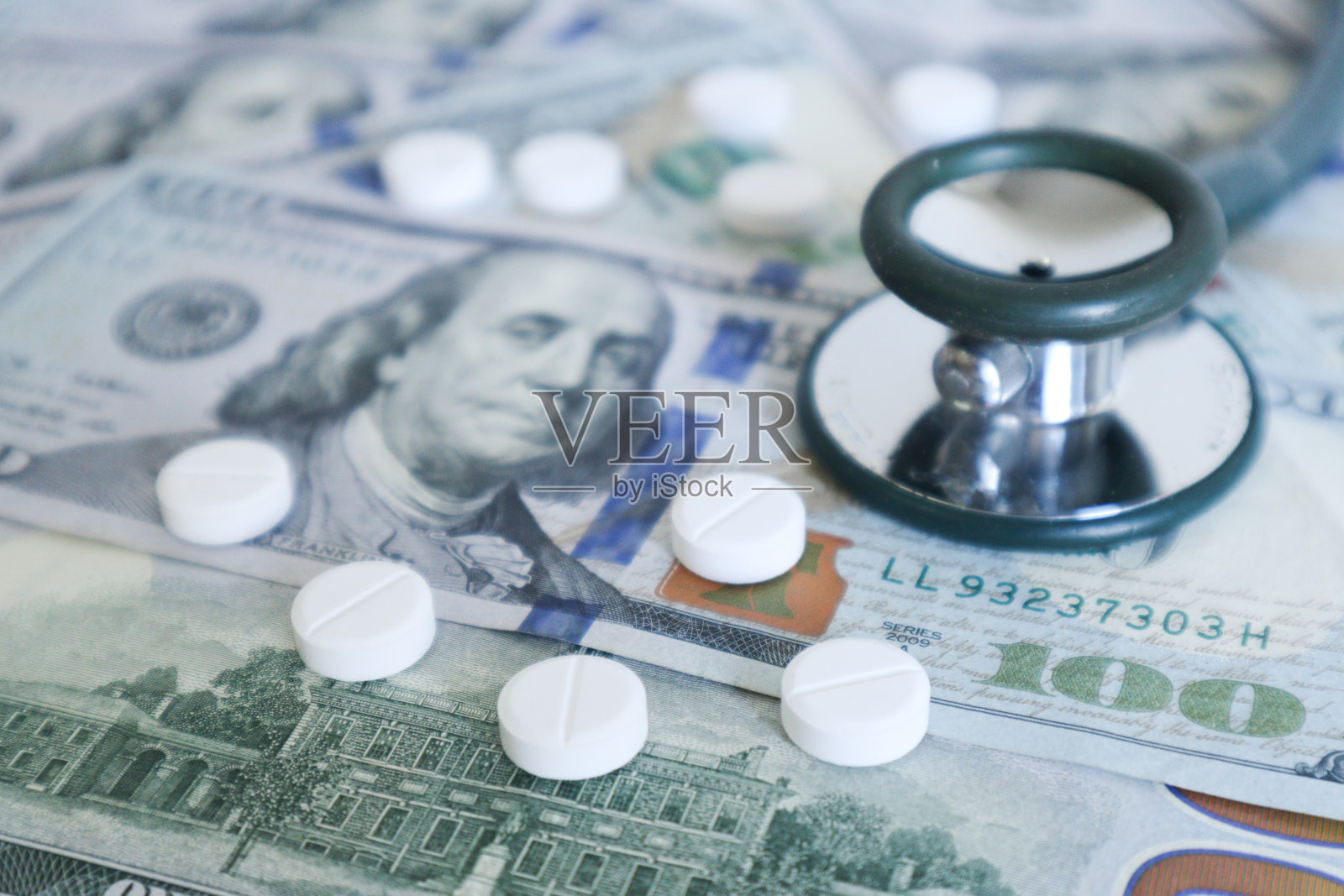 药丸和听诊器与美元背景。医疗保险和治疗费用概念照片摄影图片