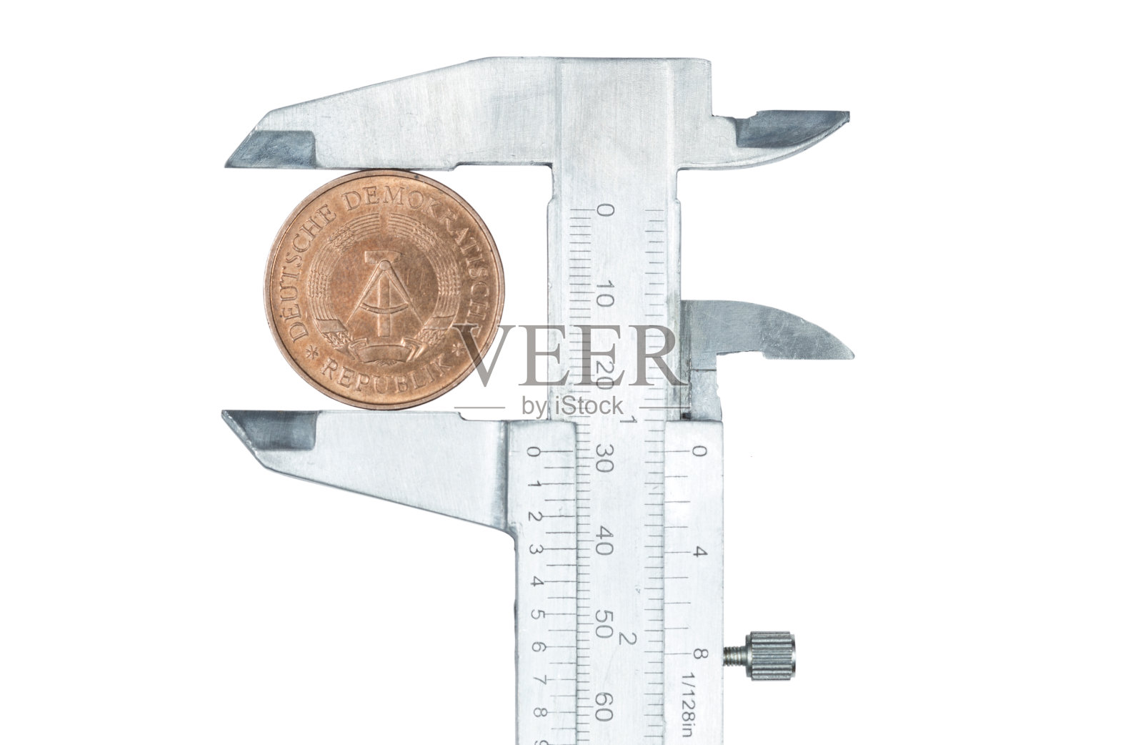 DDR硬币压在卡尺上照片摄影图片