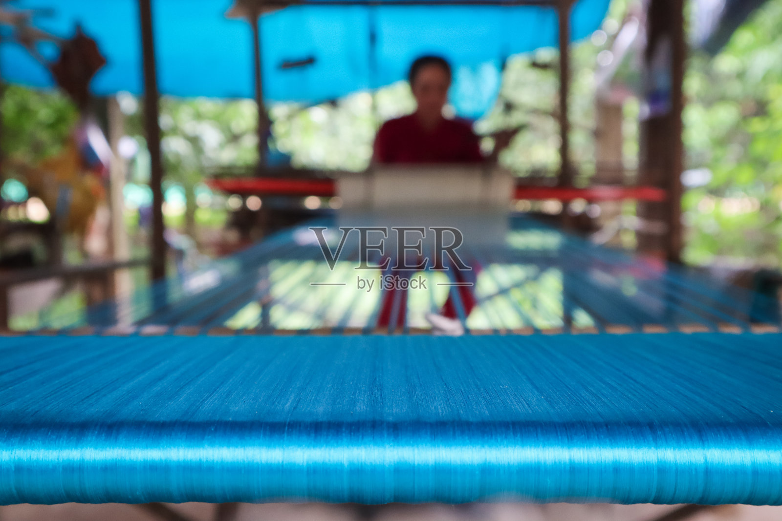 在织布机上织丝绸的妇女照片摄影图片