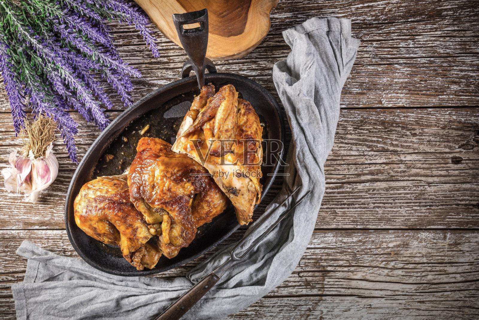 四分之一的炸鸡放在铸铁煎锅里。照片摄影图片