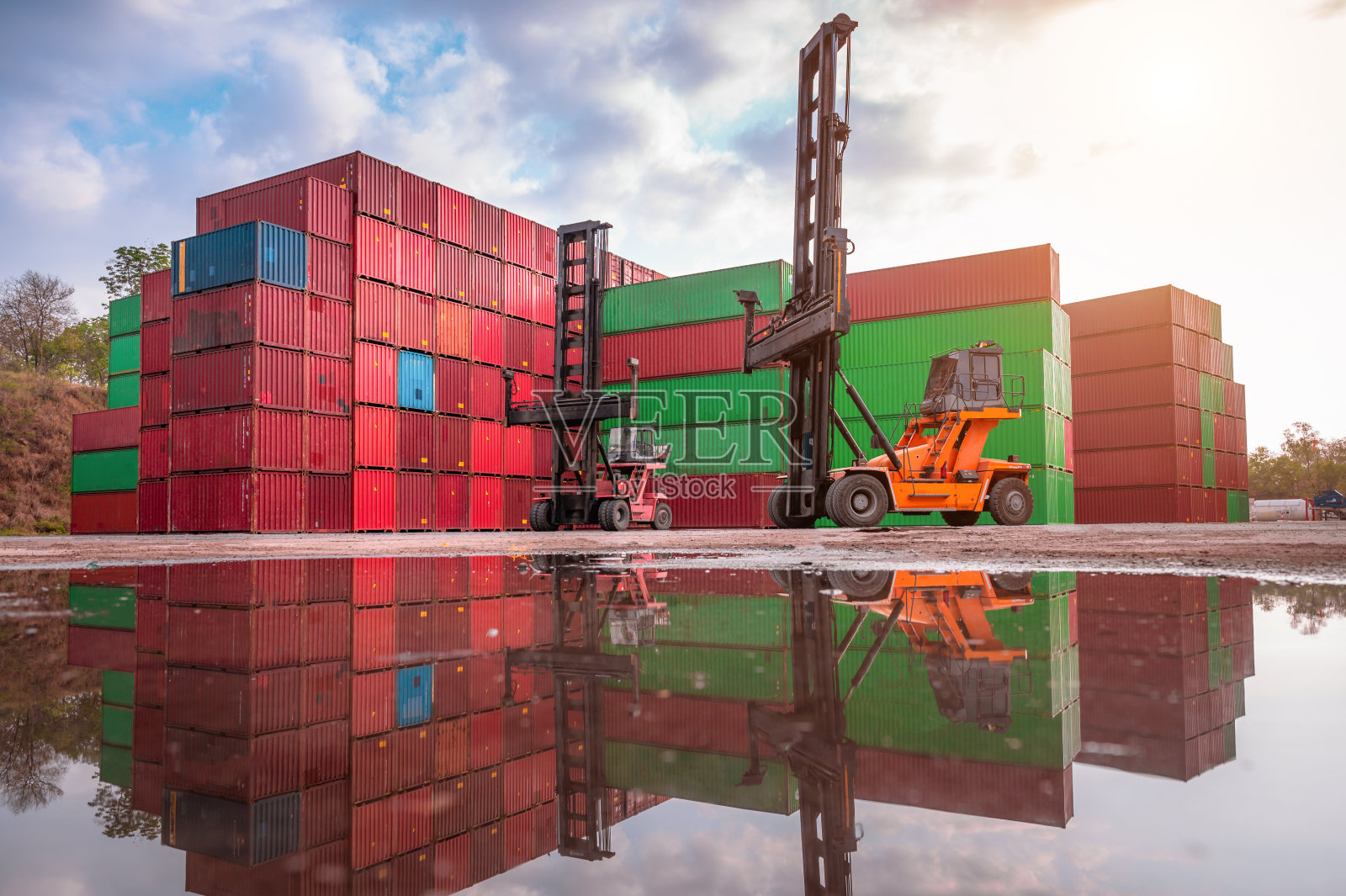 以集装箱堆场为背景的物流堆场中叉车装卸集装箱照片摄影图片