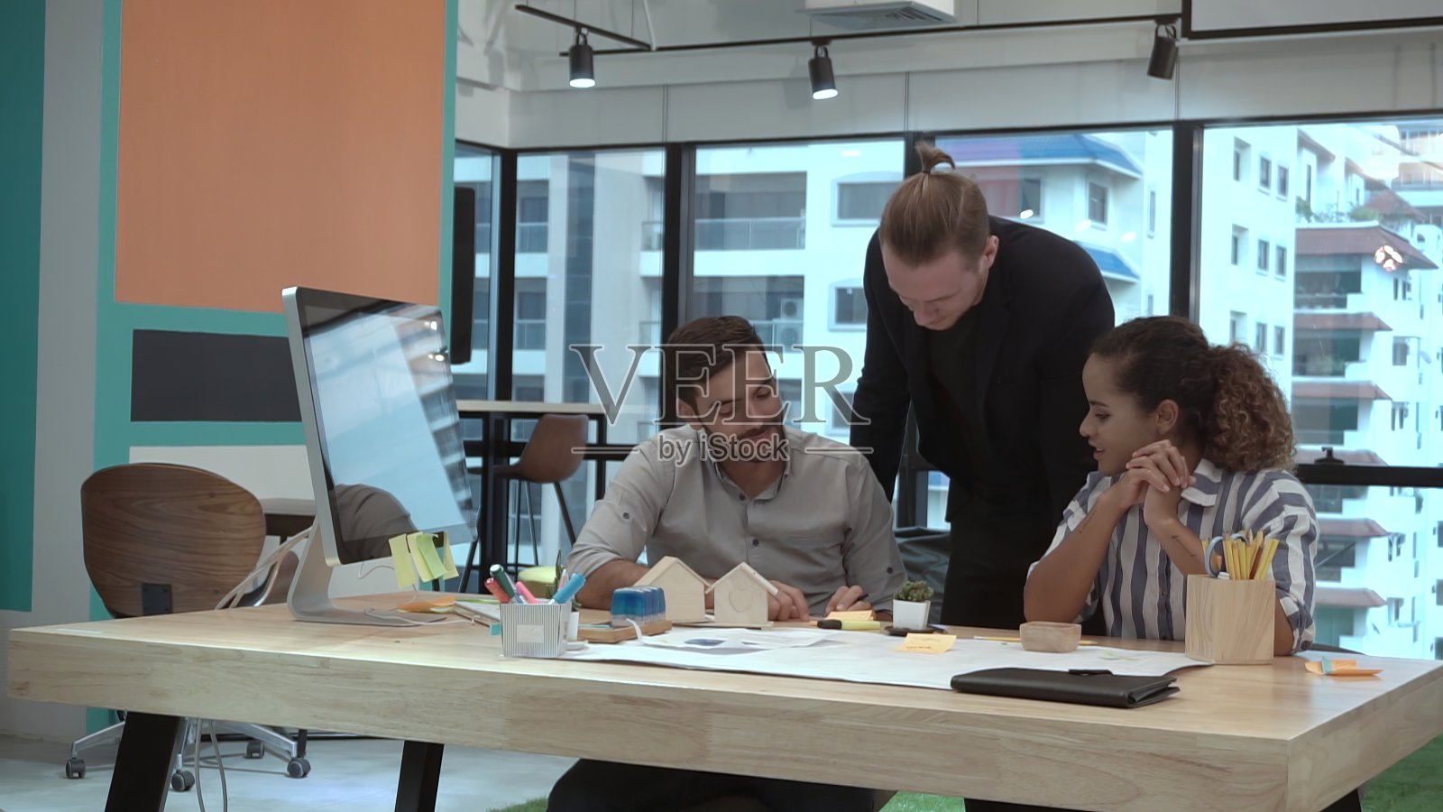 创意商务人士在办公桌旁交谈。照片摄影图片