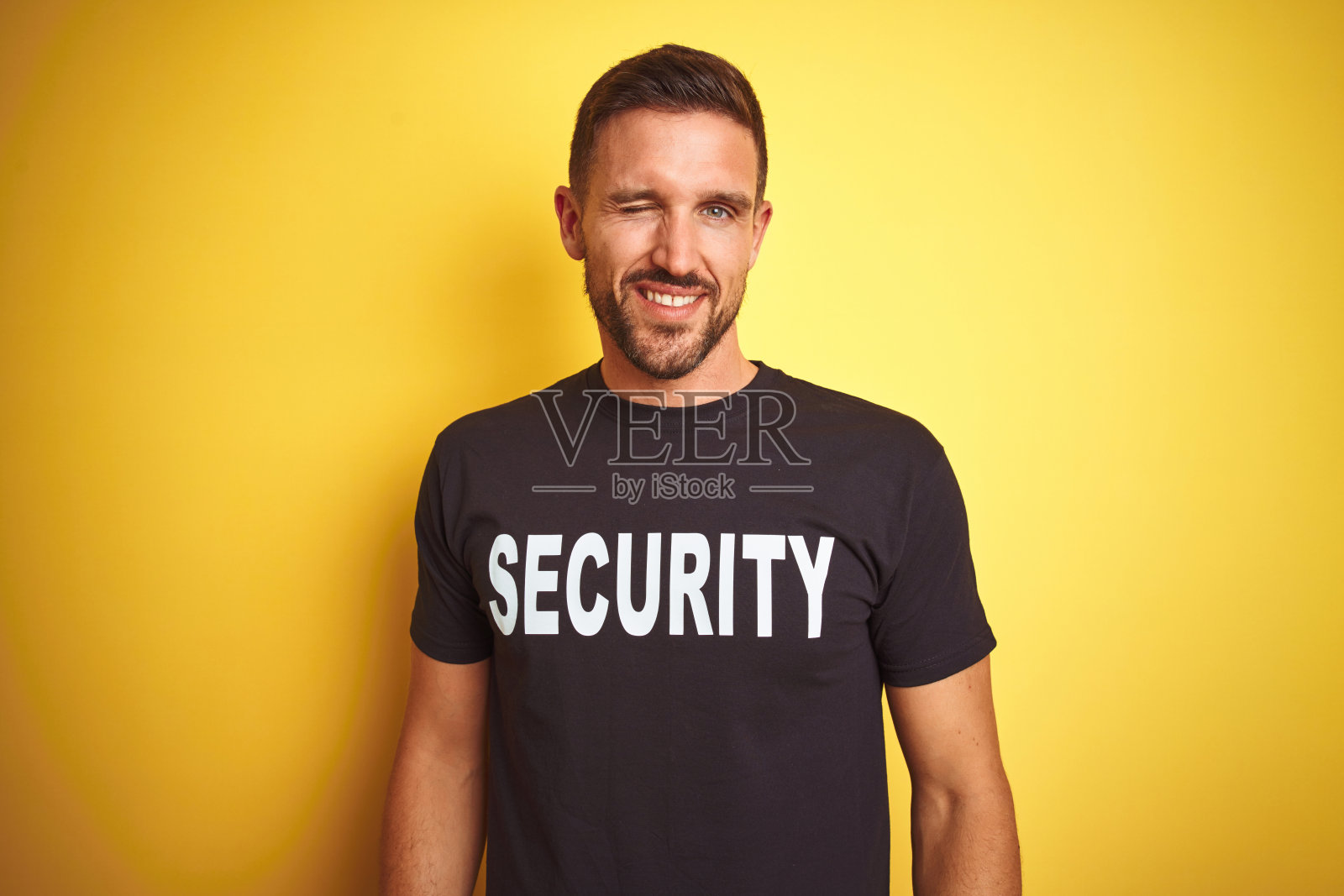 身穿保安制服，面带微笑的年轻保安照片摄影图片