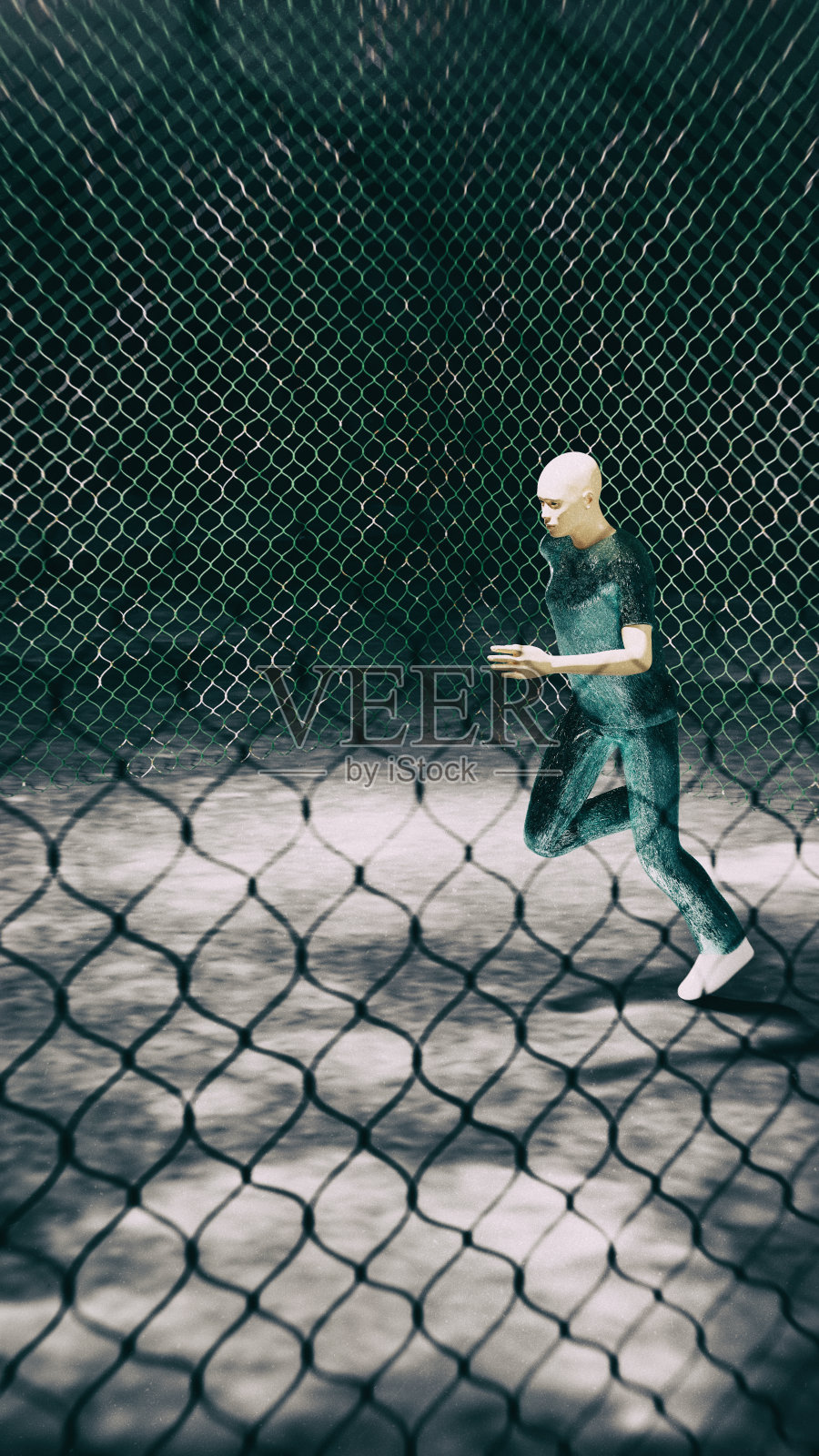 在黑暗的背景下，一个跑着的男人在金属网围栏里照片摄影图片