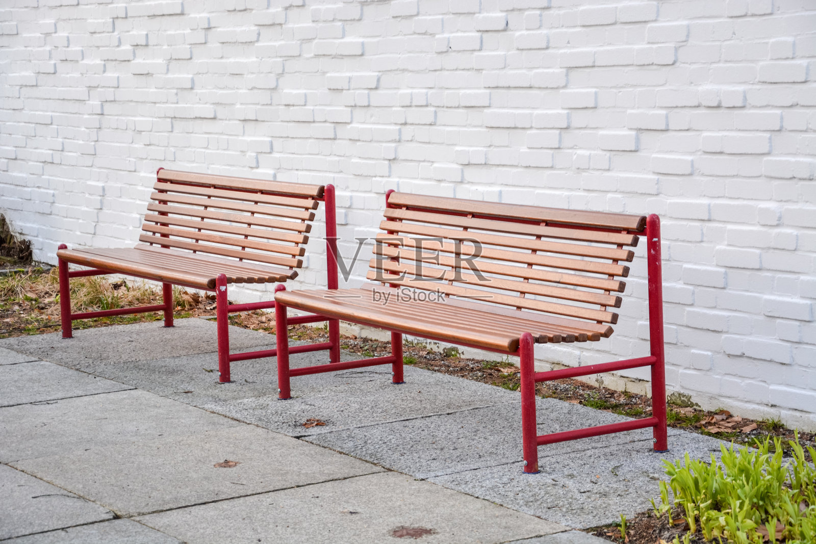 两张长凳正对着一面白墙照片摄影图片