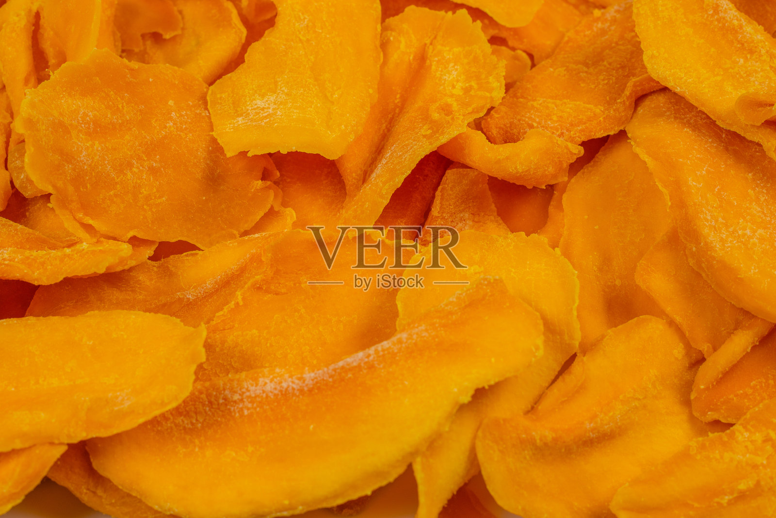 美味的糖芒果片背景。前视图。照片摄影图片