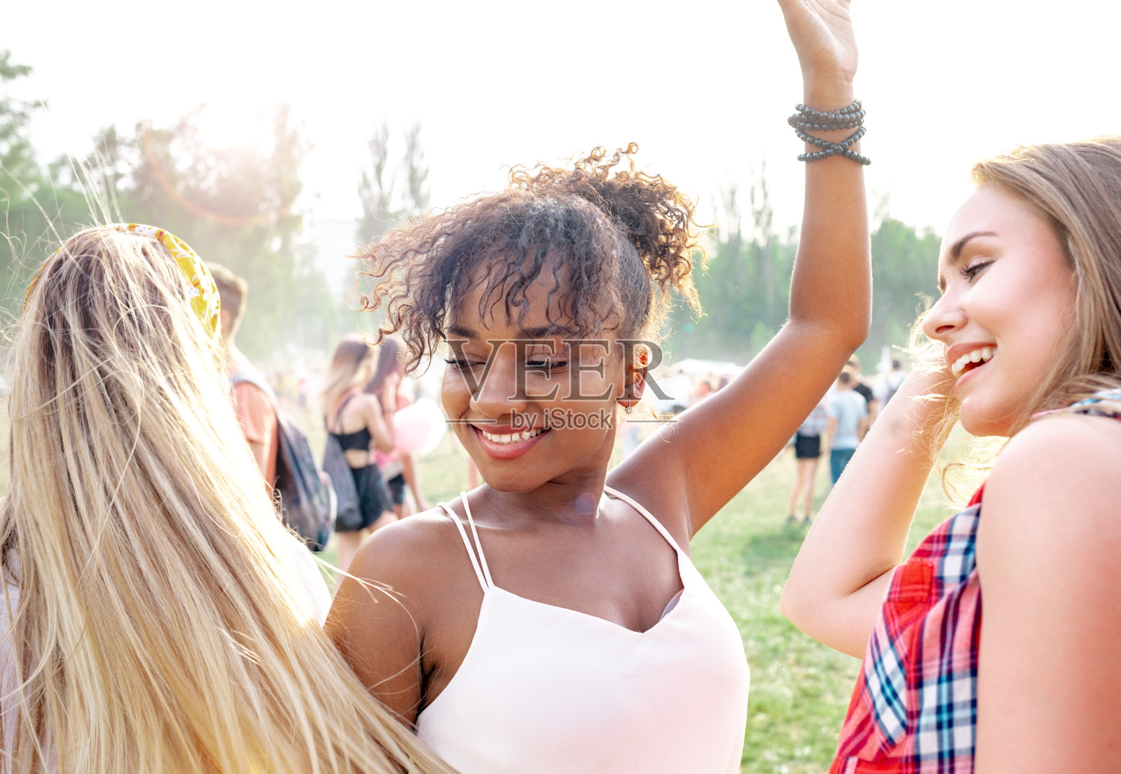 参加夏季音乐节的非裔美国年轻女子和朋友们照片摄影图片