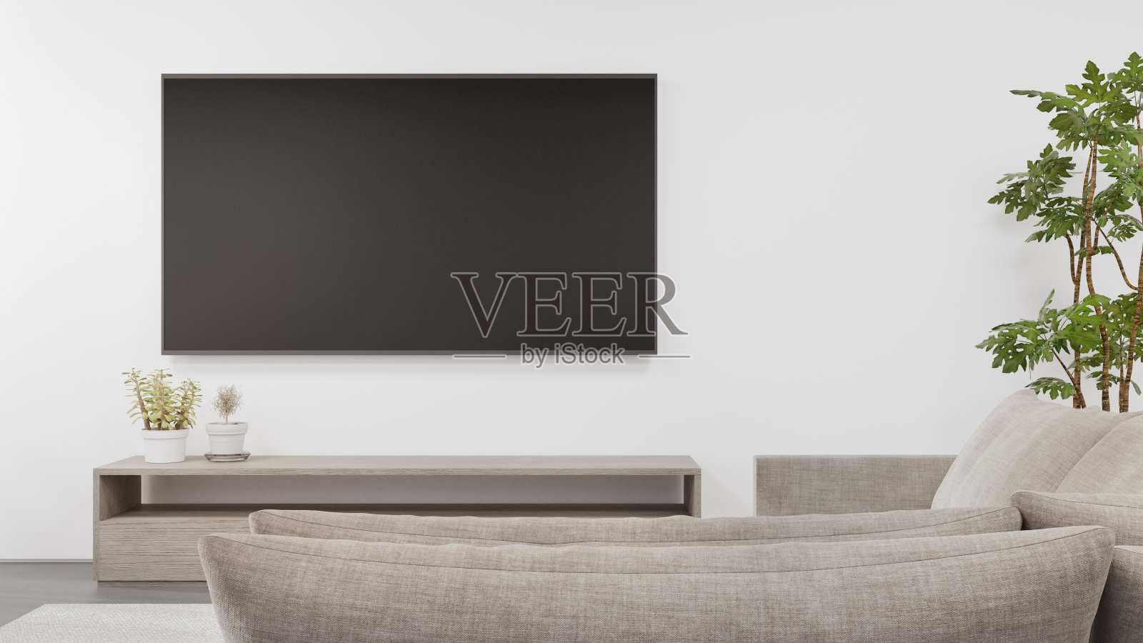 在现代住宅或公寓明亮客厅的混凝土地板上放置电视架，沙发靠在电视机上。照片摄影图片