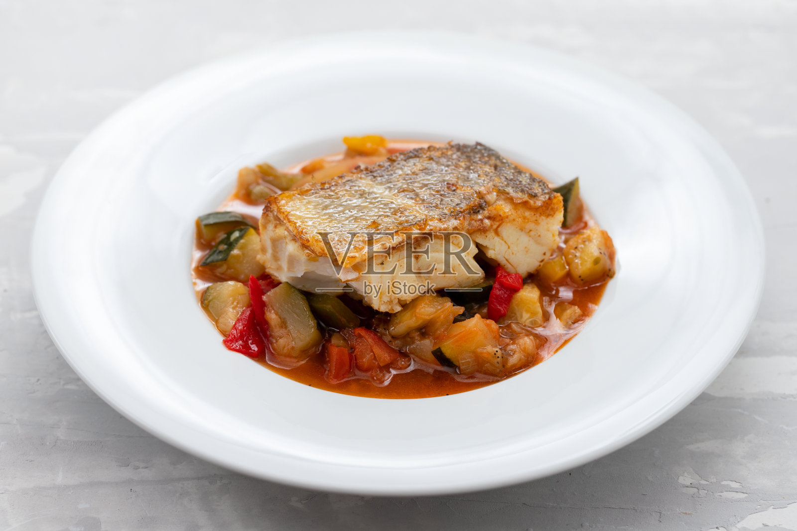 白盘子里的鳕鱼和蔬菜照片摄影图片