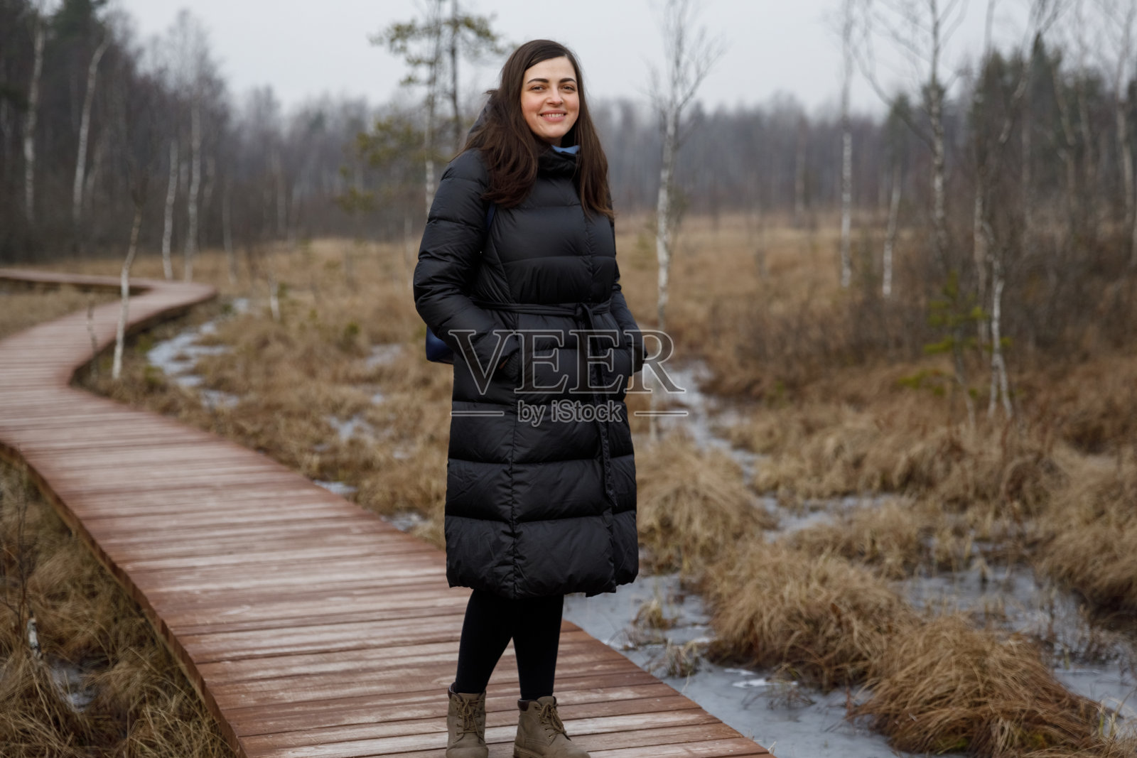 穿外套的女孩在秋日树林中照片摄影图片