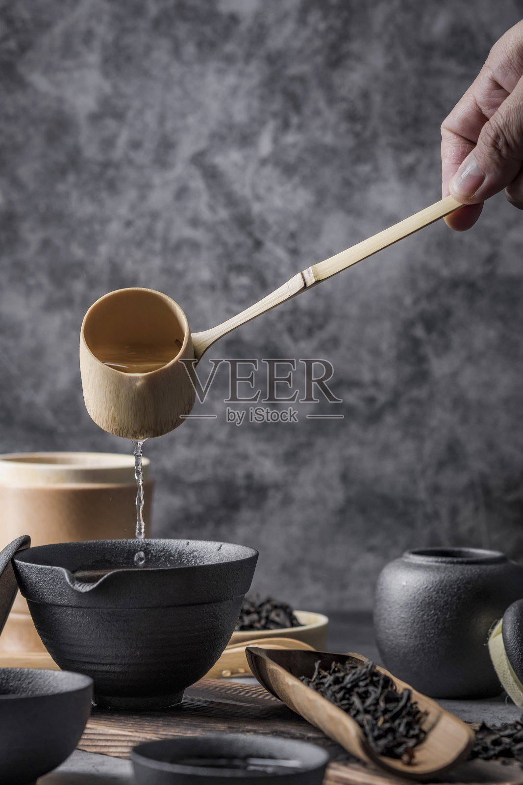 室内以中国茶道著名照片为背景的陶瓷茶壶和茶杯。照片摄影图片