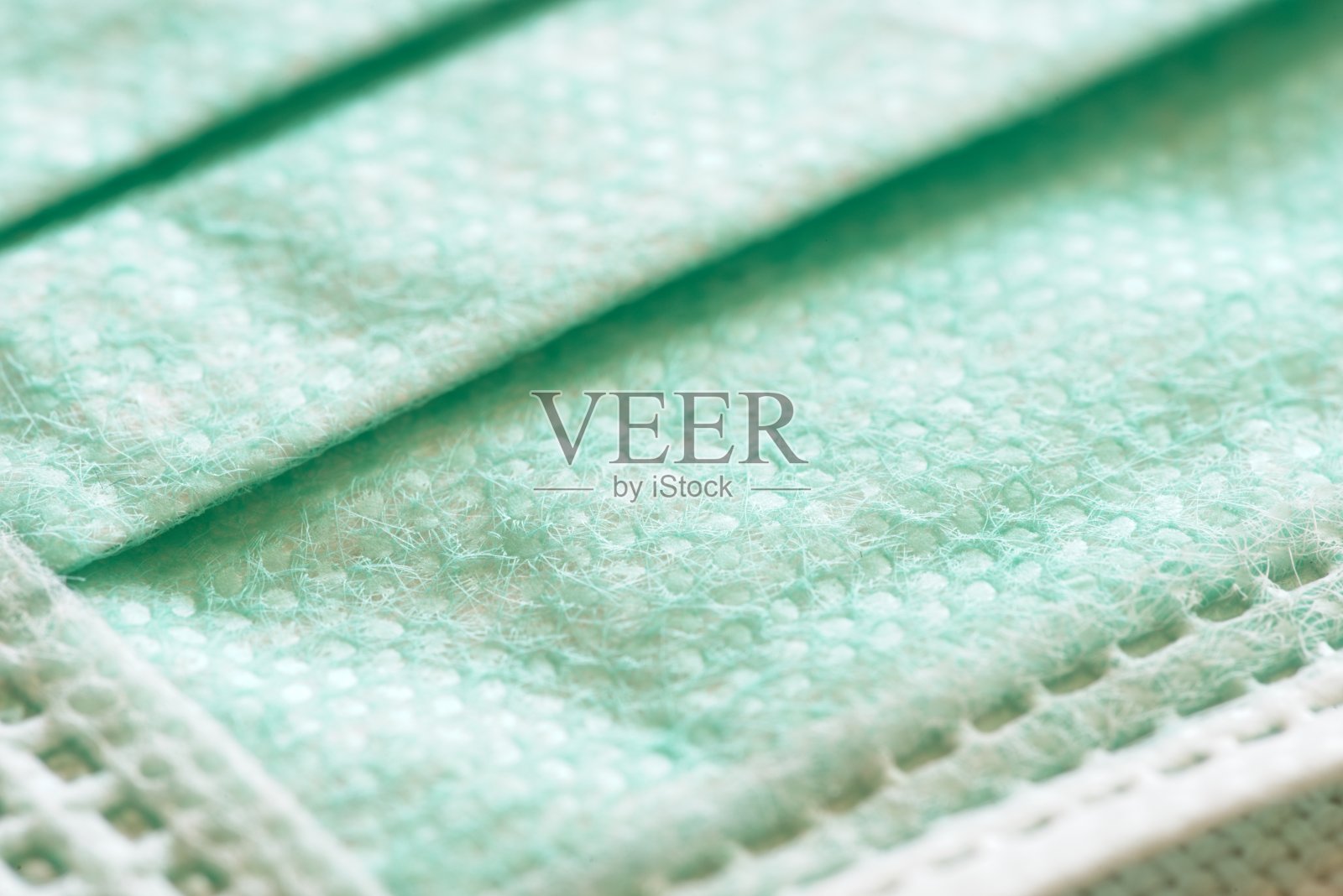 作为个人保护装置的外科医用口罩的宏观细节。照片摄影图片