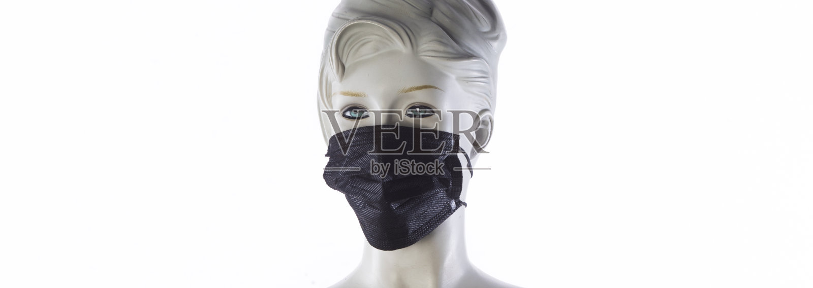 戴着防冠状病毒医用口罩的人体模型照片摄影图片