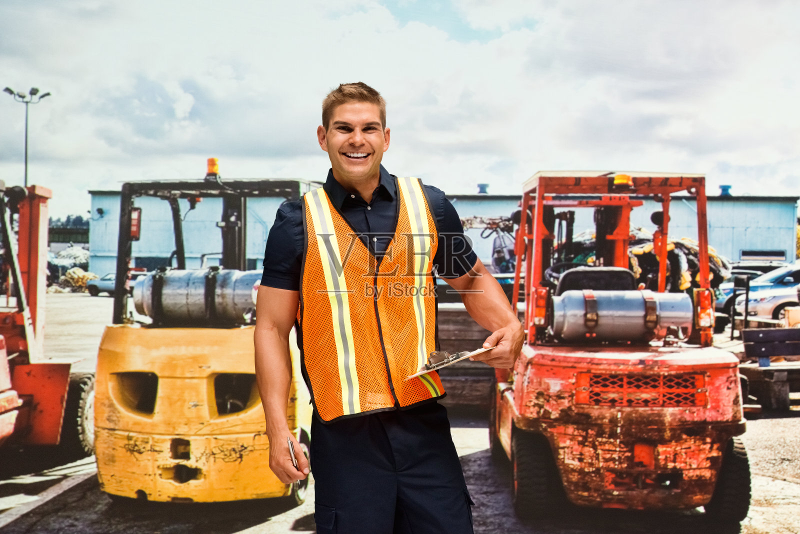 穿着马甲，手里拿着合同的年轻白人建筑承包商照片摄影图片