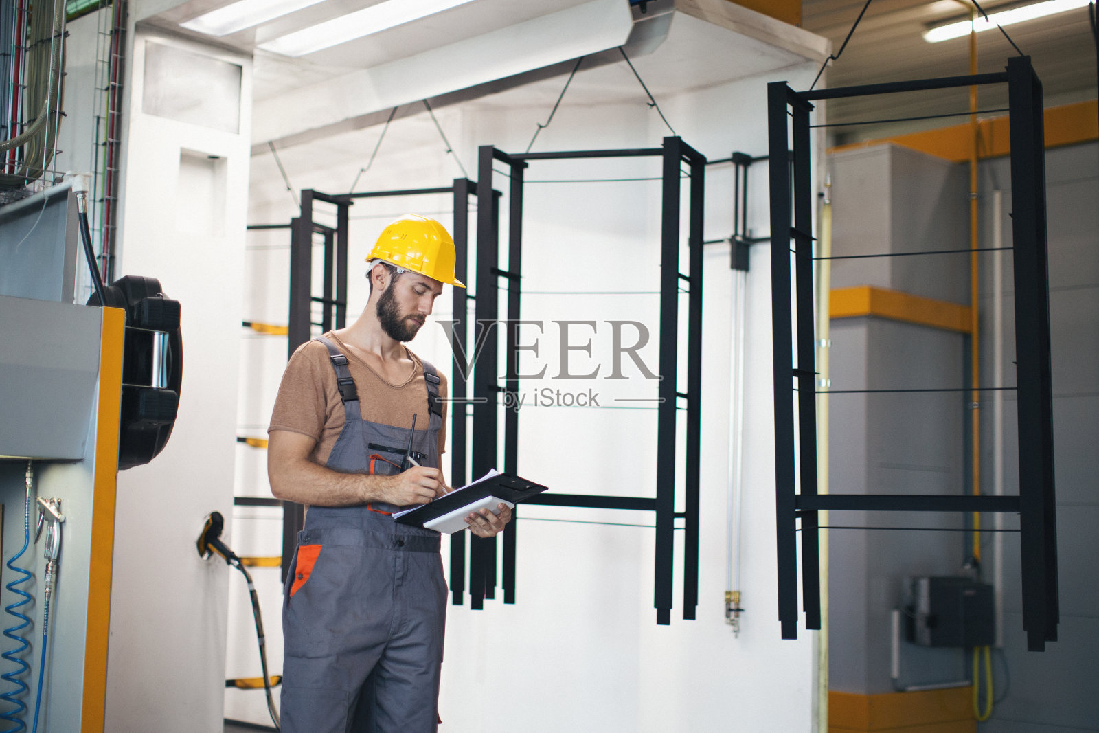 在工厂里使用和检查机器的年轻人照片摄影图片