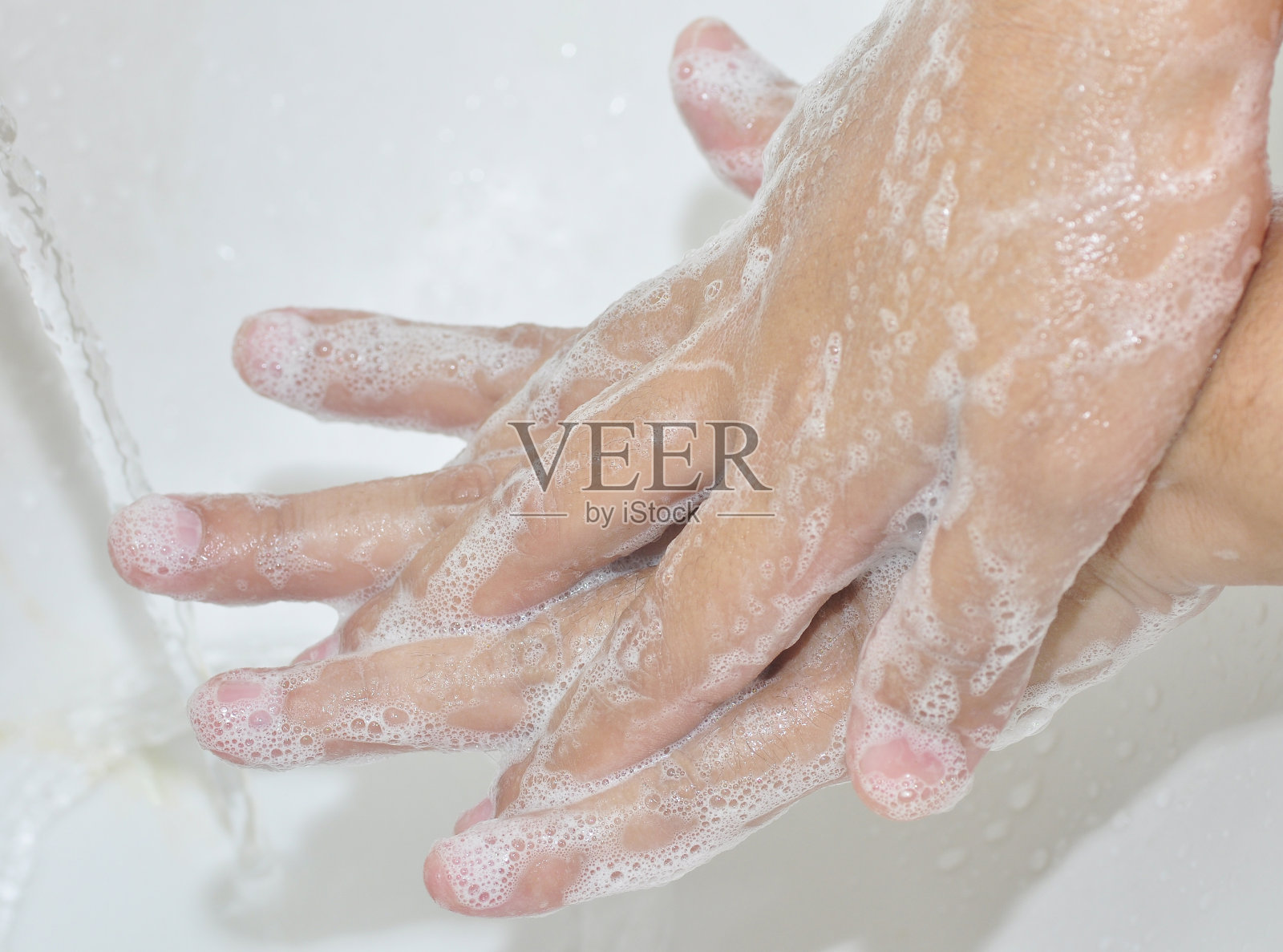 预防冠状病毒流行用肥皂洗手。照片摄影图片