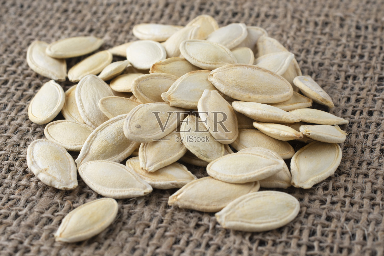 麻袋上的新鲜南瓜子。秋天的蔬菜。照片摄影图片