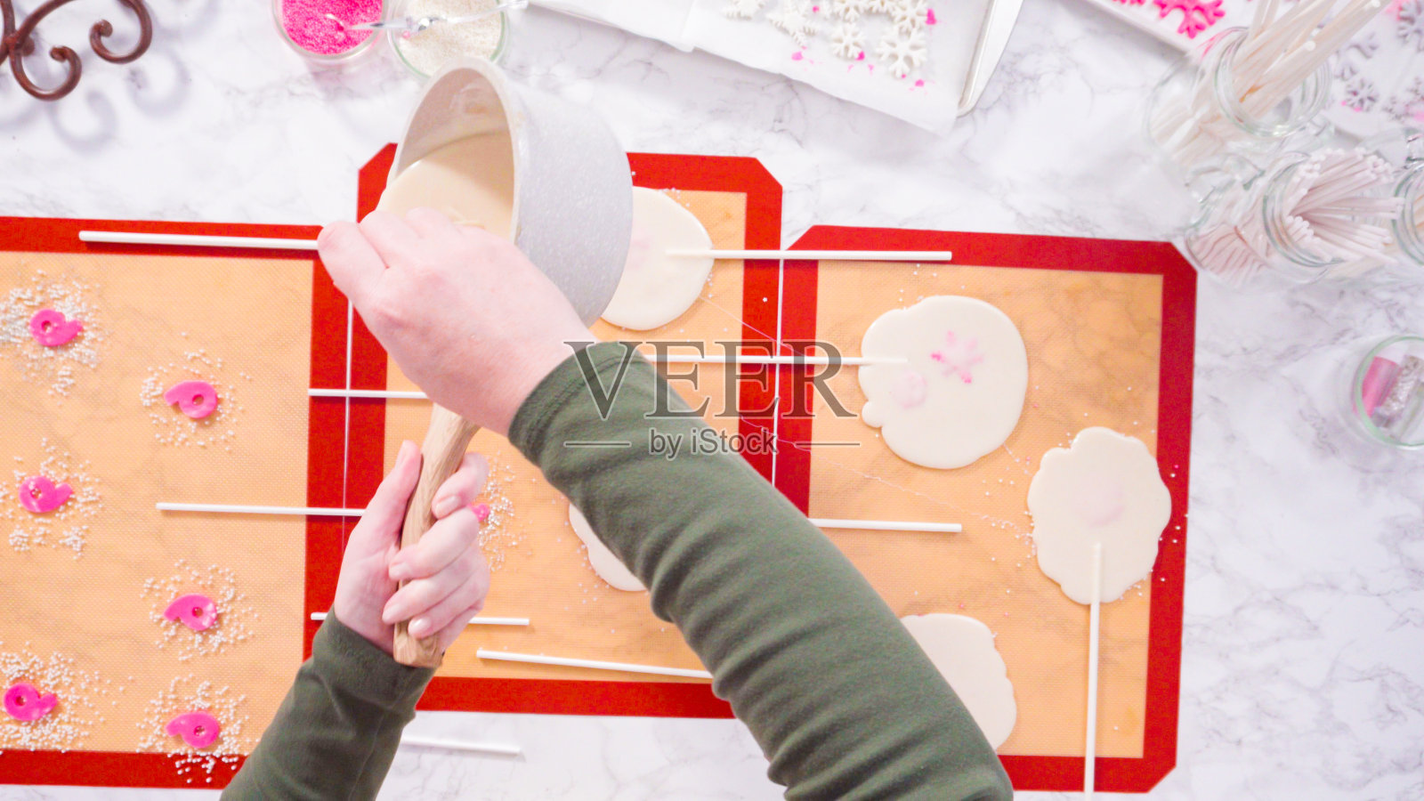 把焦糖倒在硅胶垫上自制棒棒糖。照片摄影图片