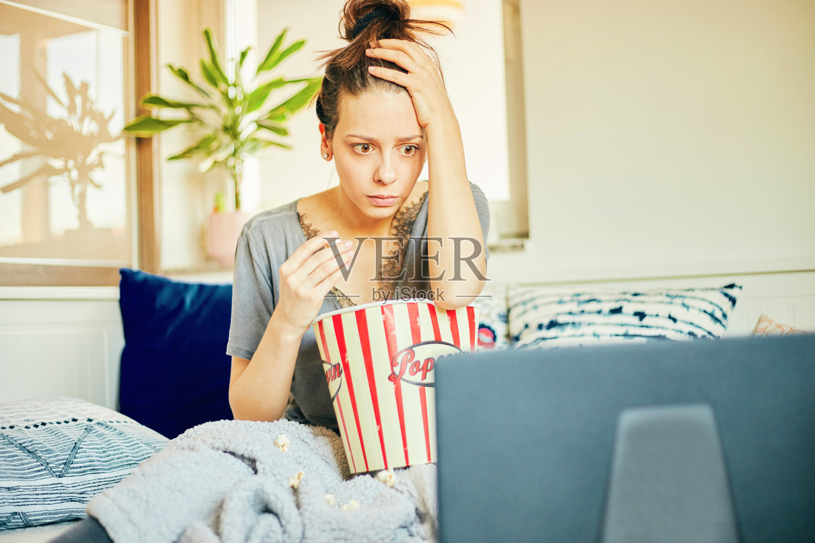 在家吃爆米花看电影的可爱女人照片摄影图片