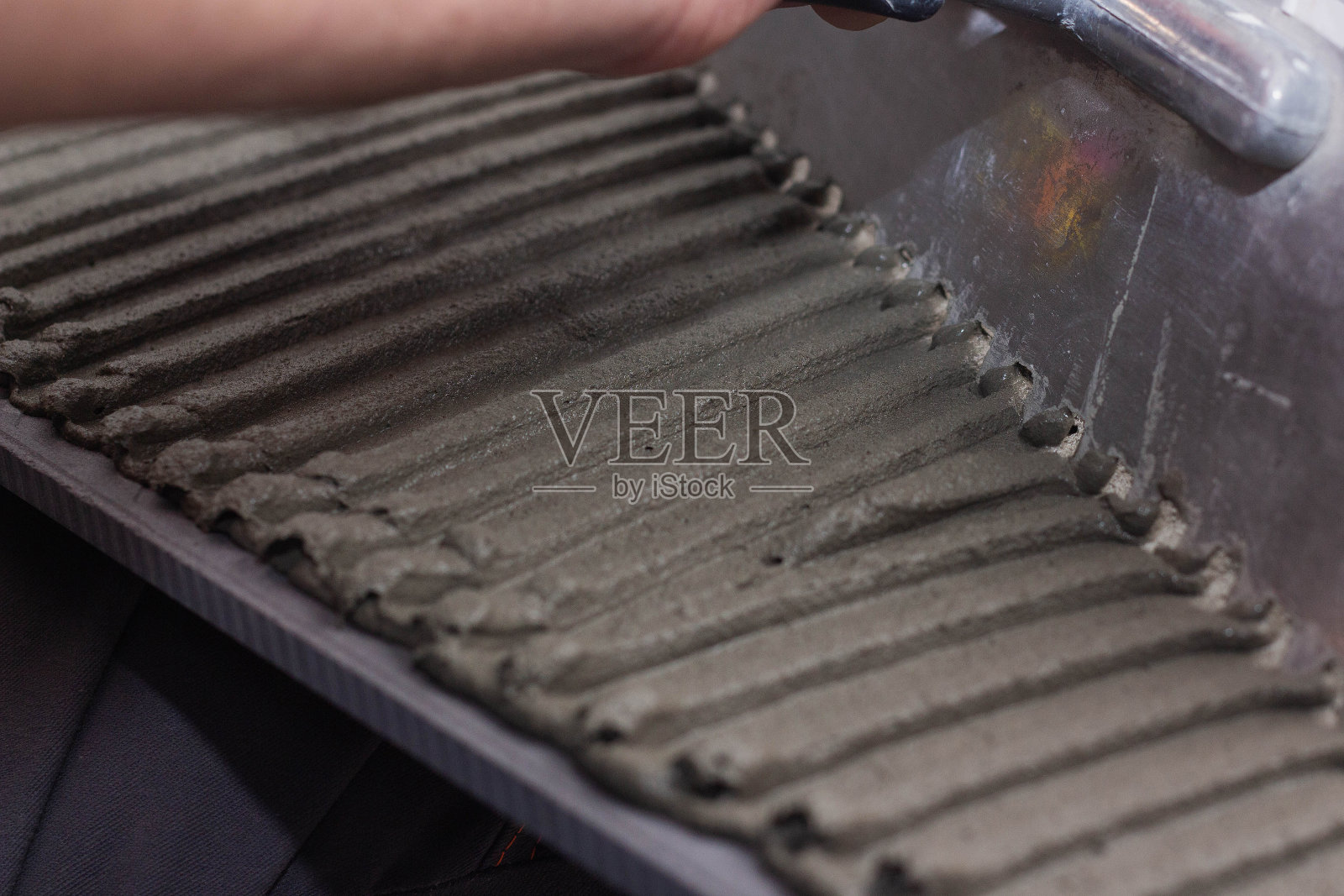 在瓷砖上涂抹瓷砖粘合剂照片摄影图片