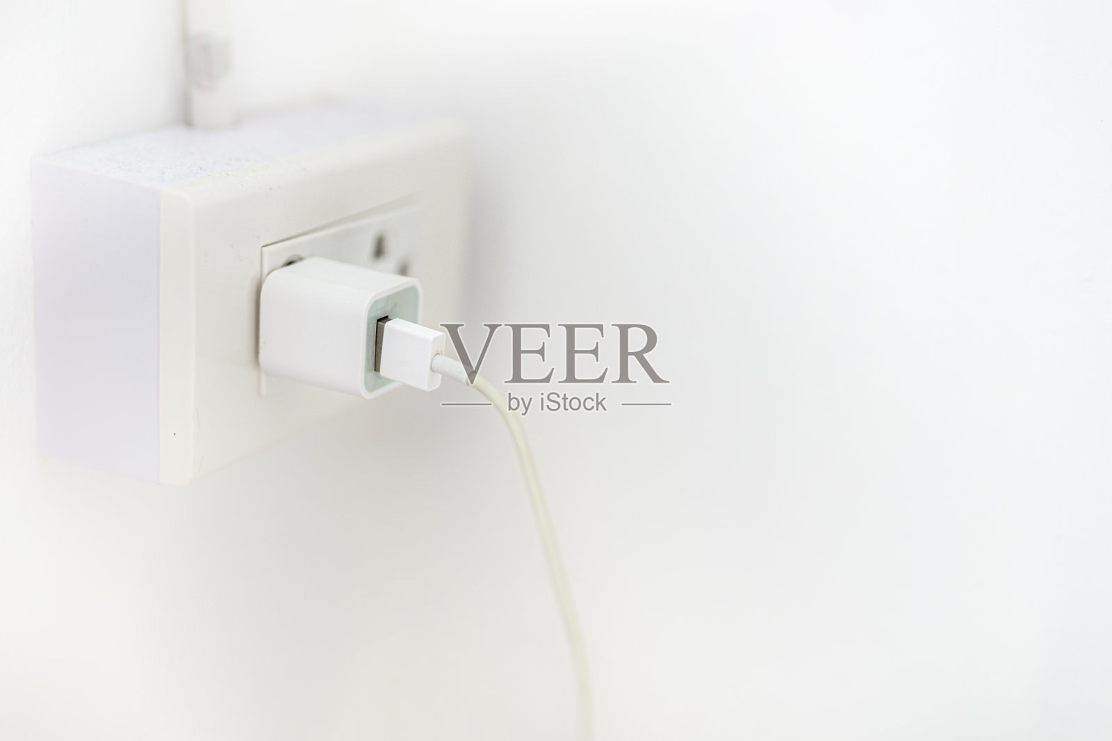 用墙壁插座给手机充电照片摄影图片