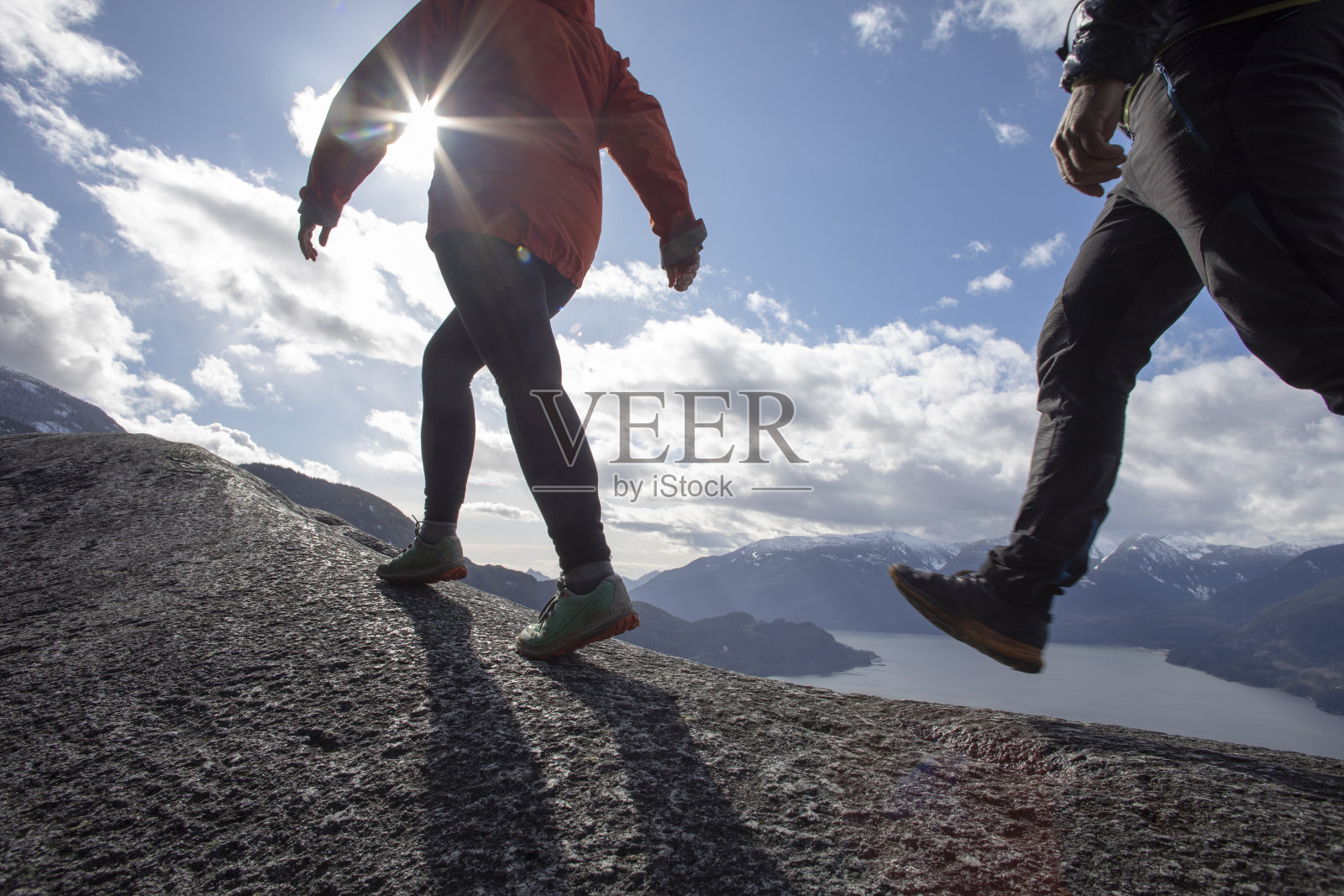 登山运动员沿着山脊行走照片摄影图片