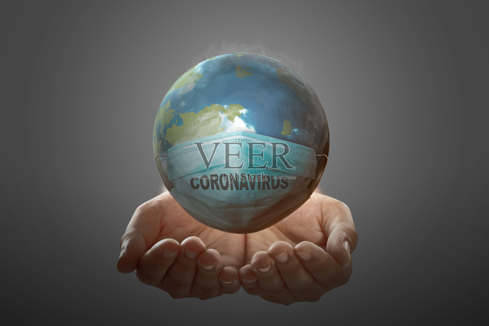 戴着流感口罩的人类手握着地球照片摄影图片