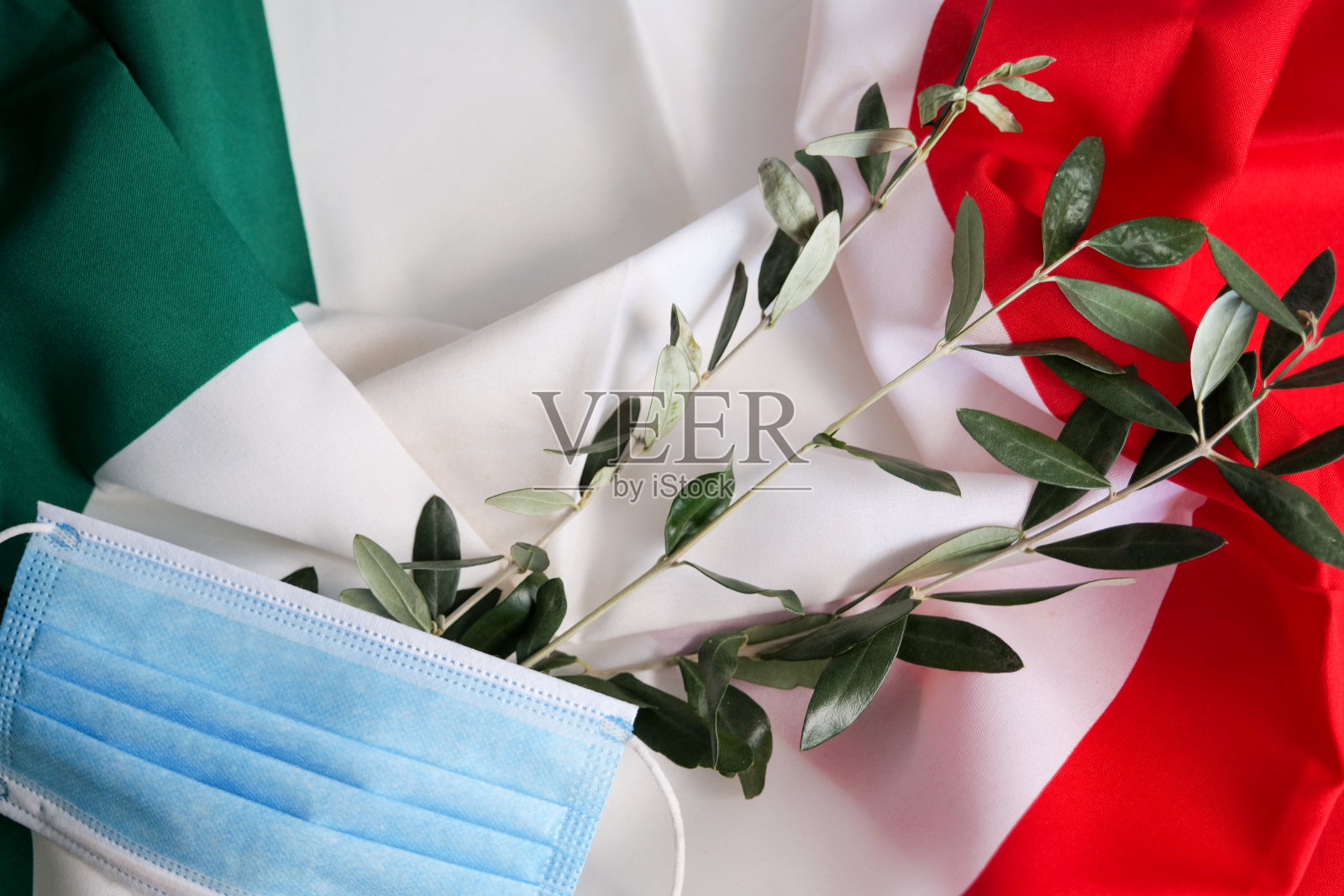 医用口罩和意大利国旗上的橄榄枝照片摄影图片
