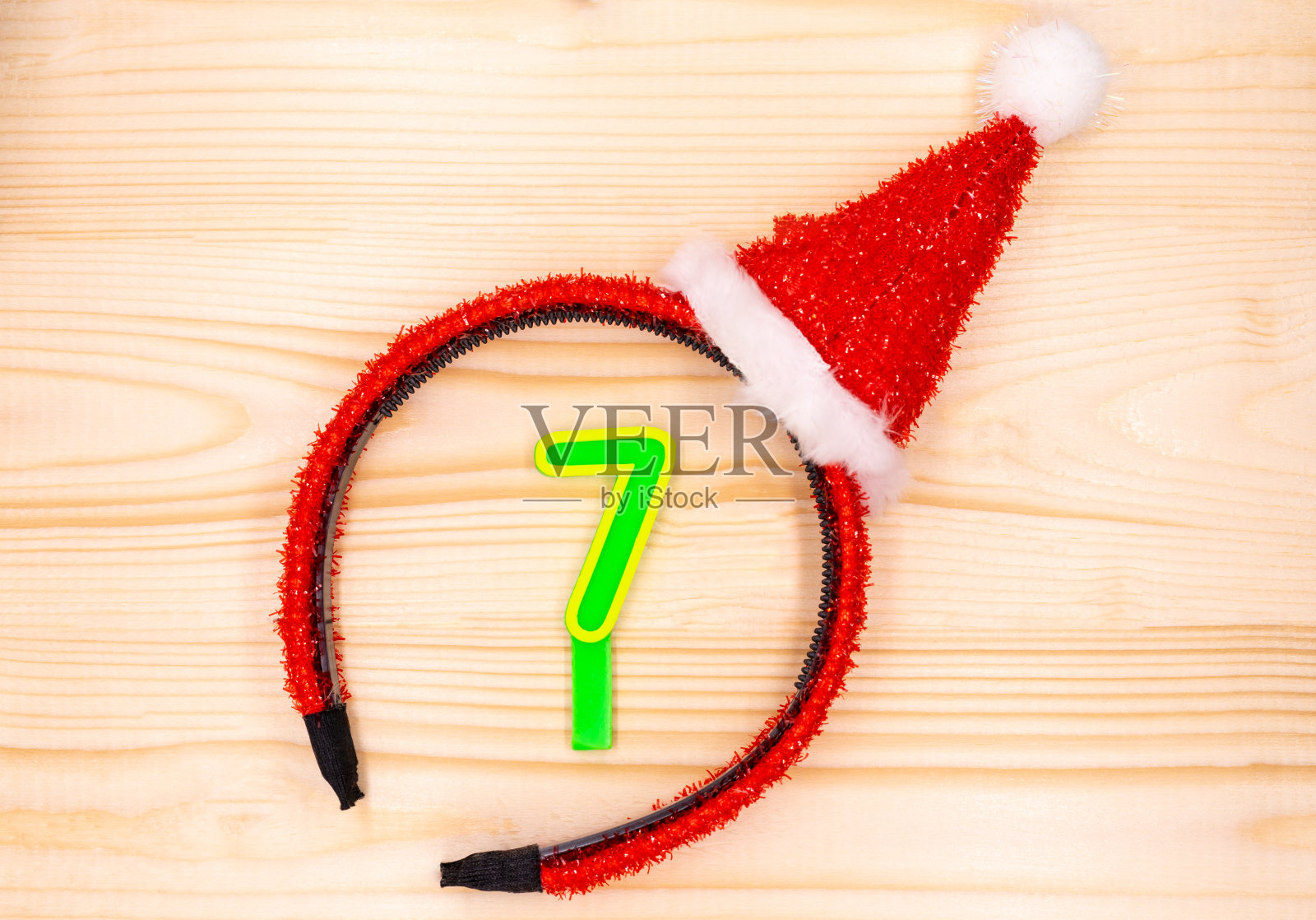 发带把数字7放在顶角的木桌上庆祝圣诞节。照片摄影图片