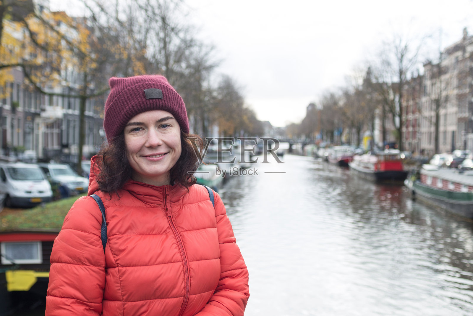 一个年轻女子的肖像。一个女人站在阿姆斯特丹运河上的桥上。照片摄影图片