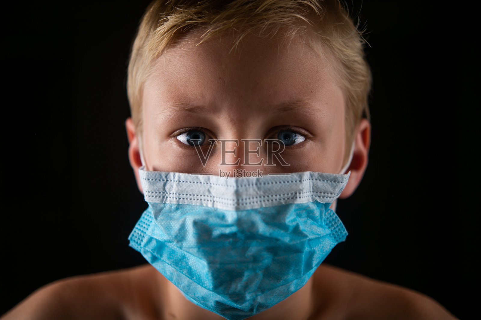 男孩外科手术面具肖像头部拍摄与蓝色眼睛。照片摄影图片