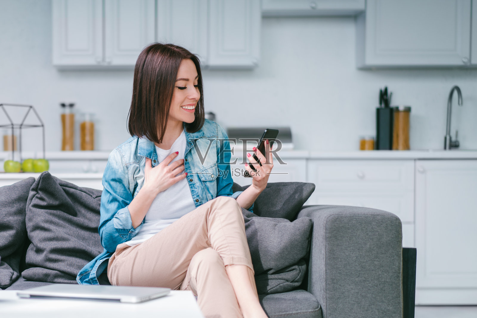 年轻女子用笔记本电脑在博彩网站上下注，庆祝中奖照片摄影图片