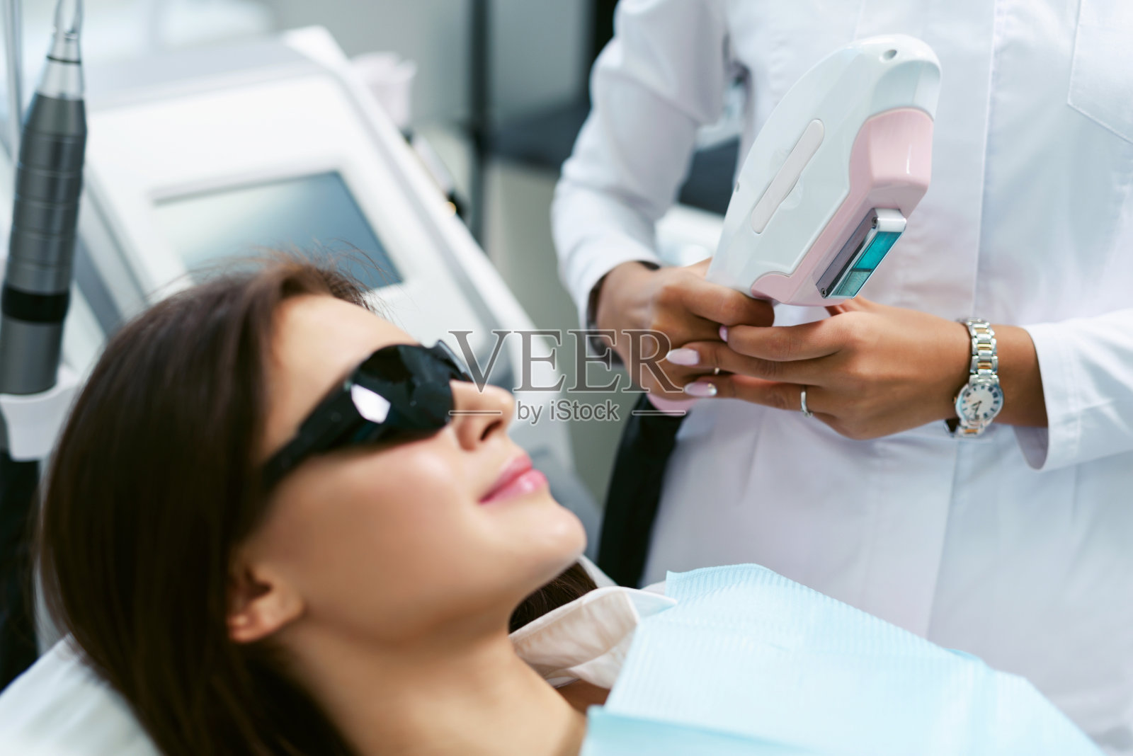 激光脱毛和美容。照片脱毛程序为年轻女性美容诊所与美容师医生。SPA养生美容理念。光滑的皮肤照片摄影图片