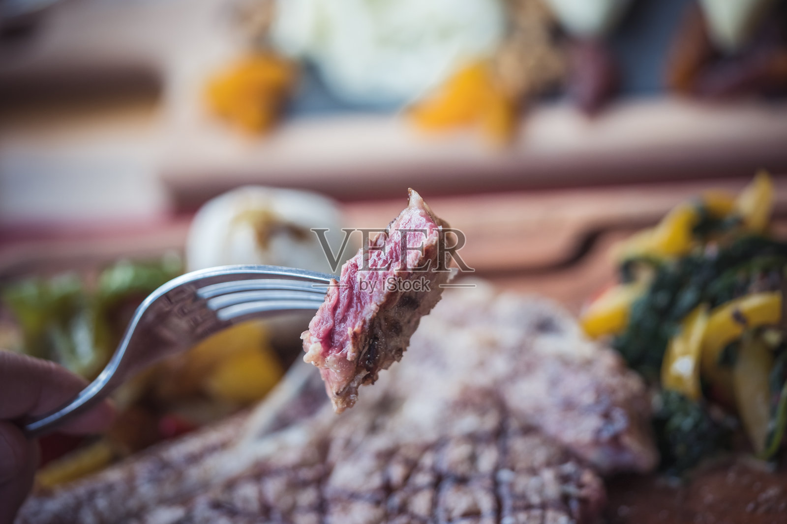 用叉子切一片肉照片摄影图片