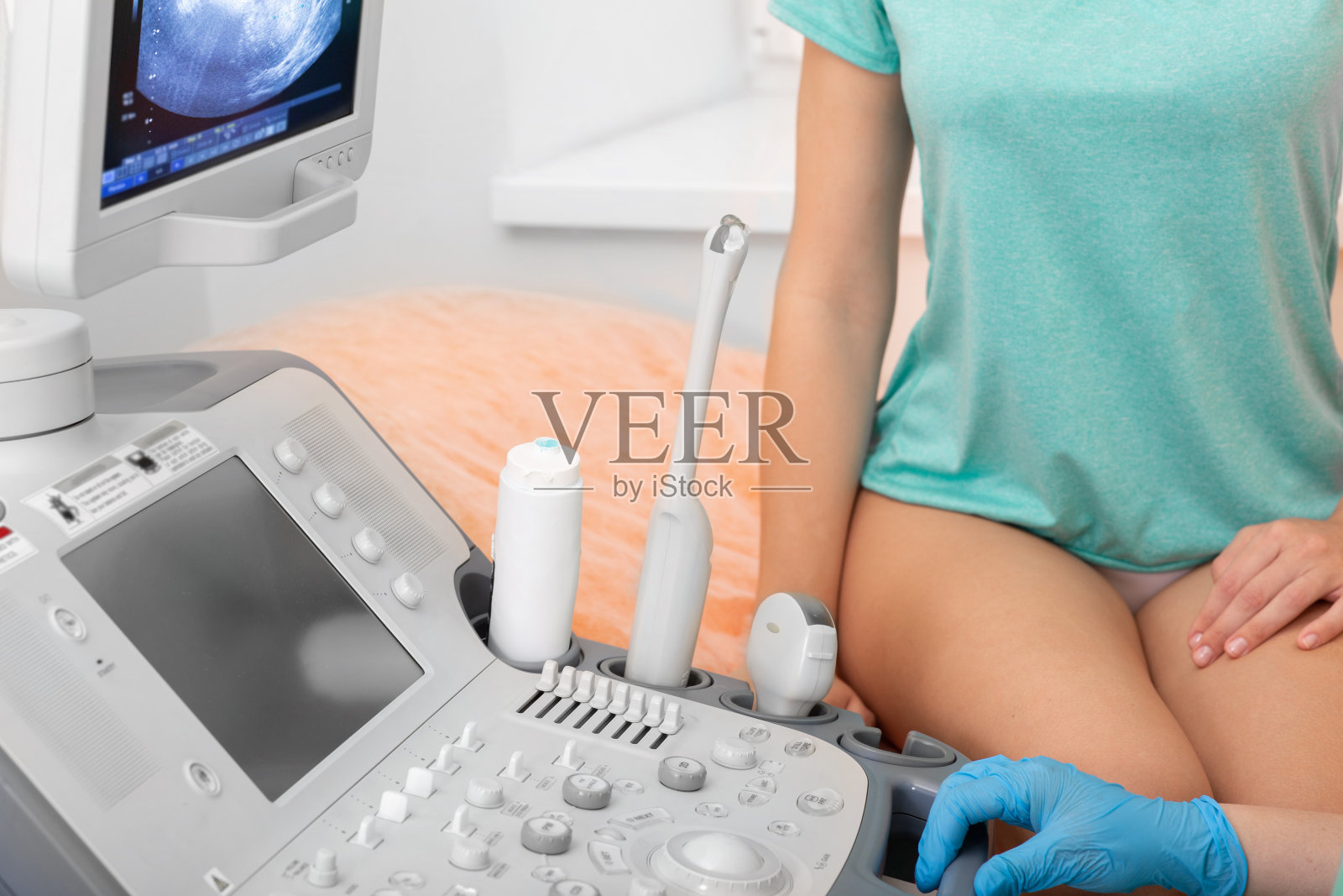 妇科医生将一种特殊凝胶应用于阴道传感器。经阴道超声检查子宫和卵巢照片摄影图片