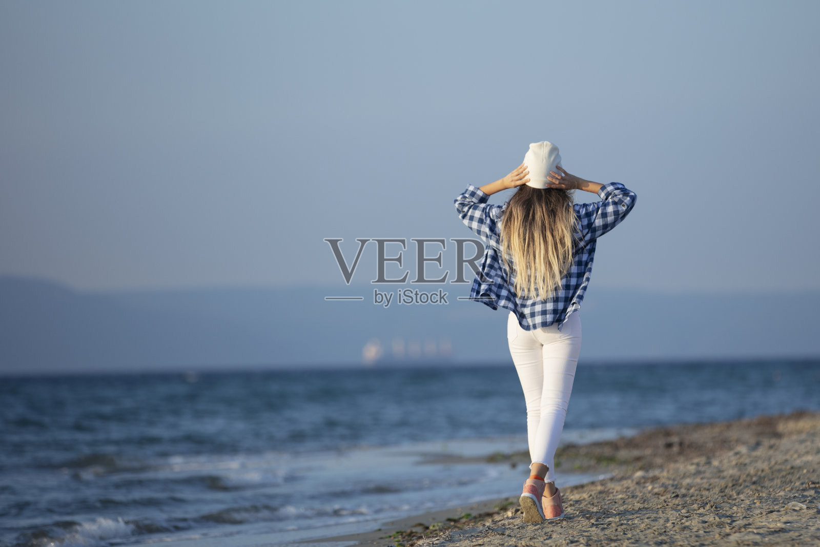 秋日沙滩上的自由女子照片摄影图片