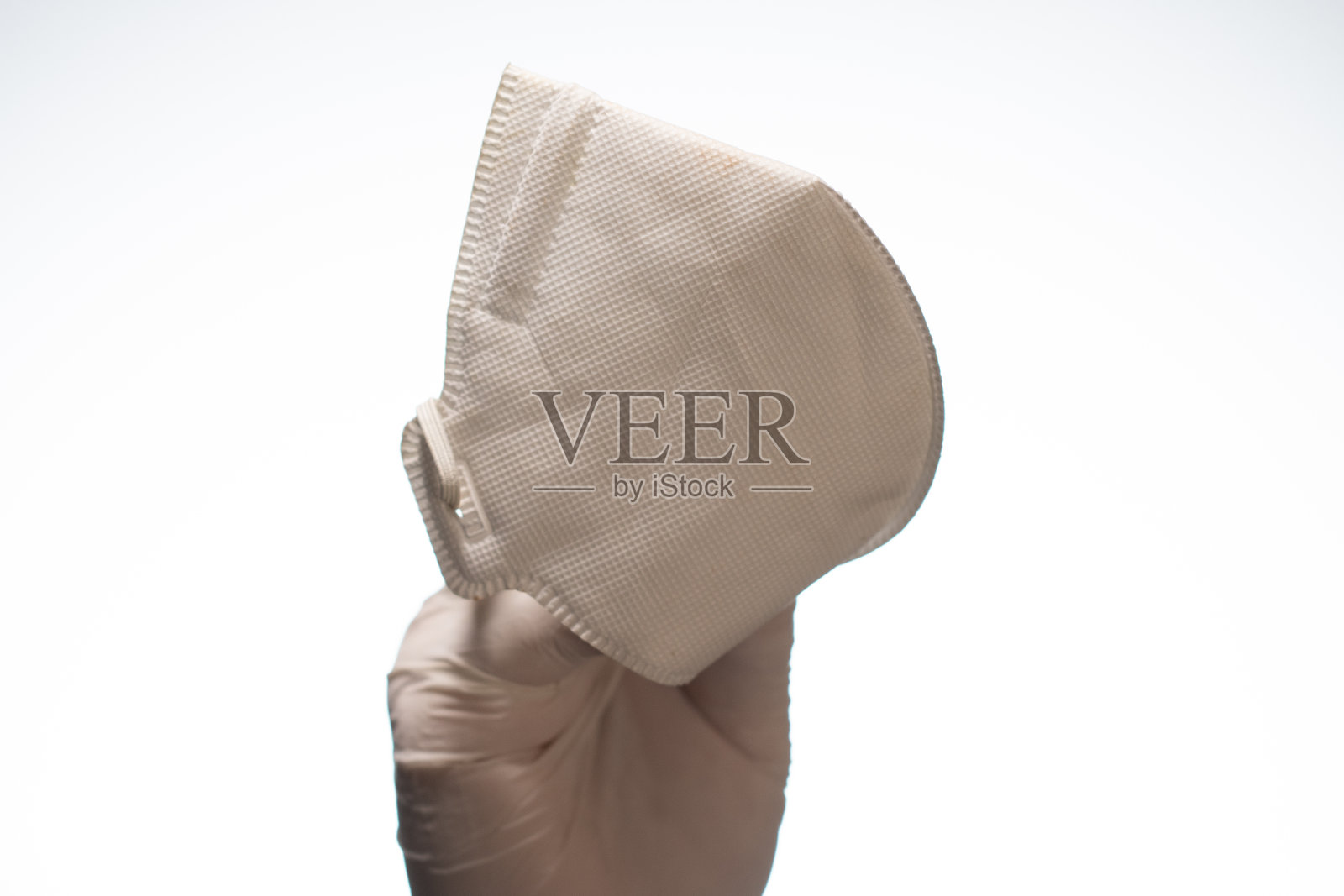 手持医用口罩，白色背景照片摄影图片