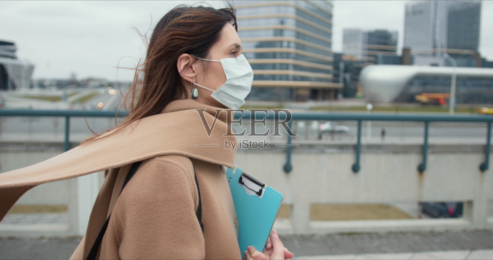 冠状病毒传染病隔离。社会福利工作者的肖像，年轻的黑发妇女在医疗保护面具外面照片摄影图片