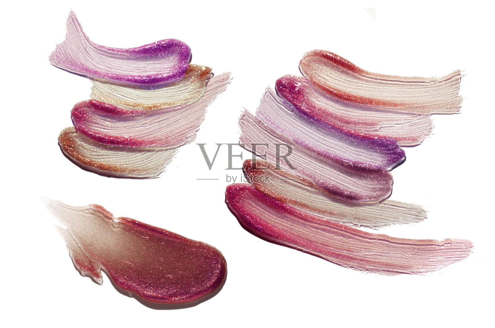 粉红紫色暗红色闪光唇彩在白色的背景照片摄影图片