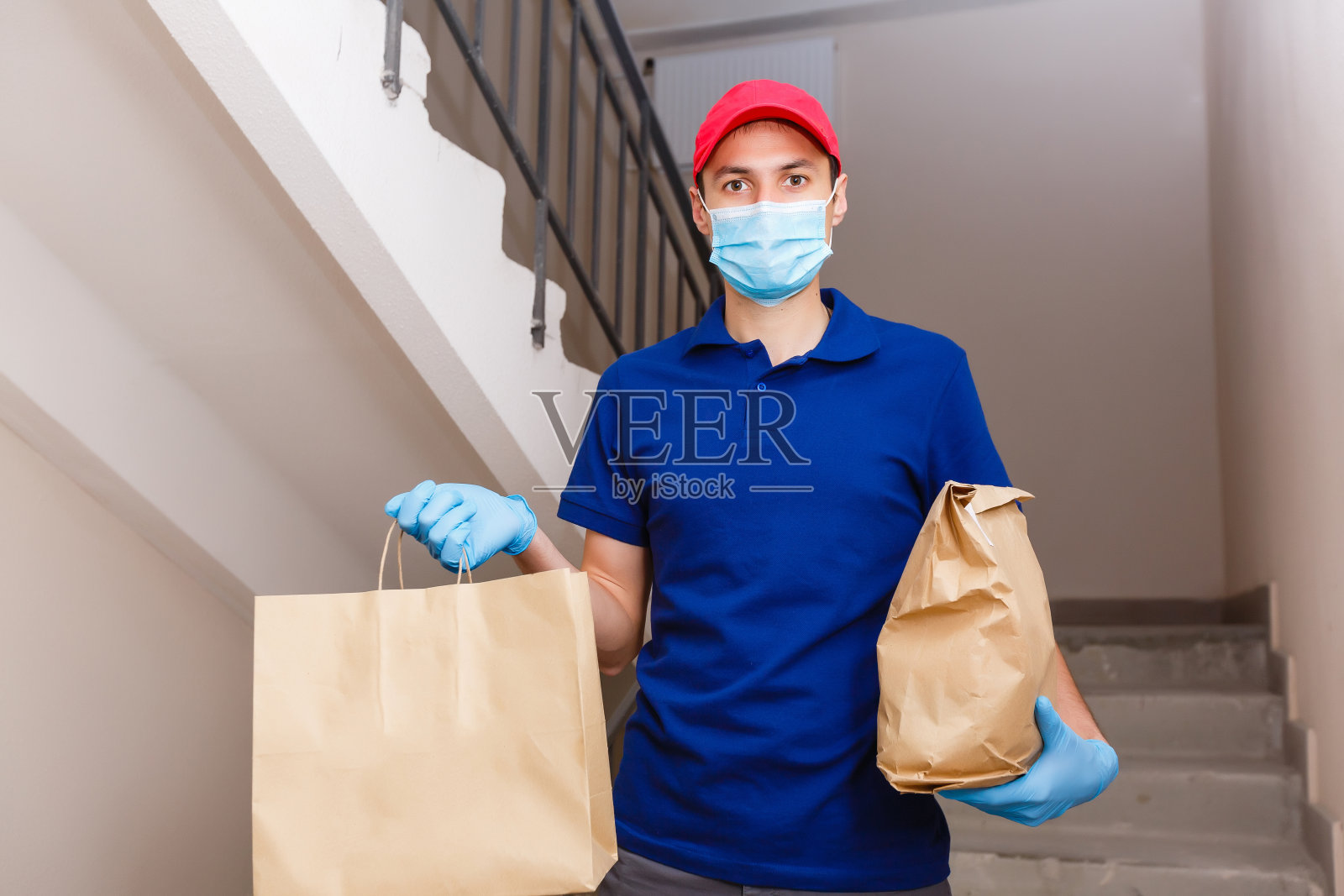 戴着防护面具的送餐员照片摄影图片