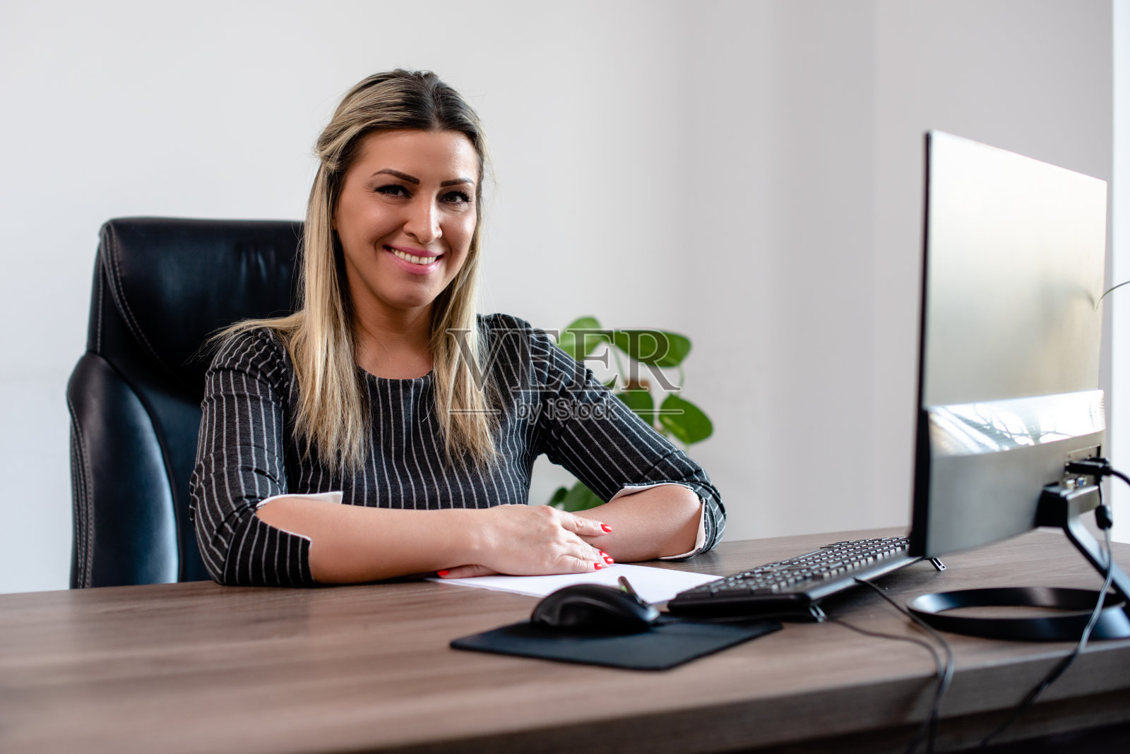 办公室里的女商人看着照相机照片摄影图片