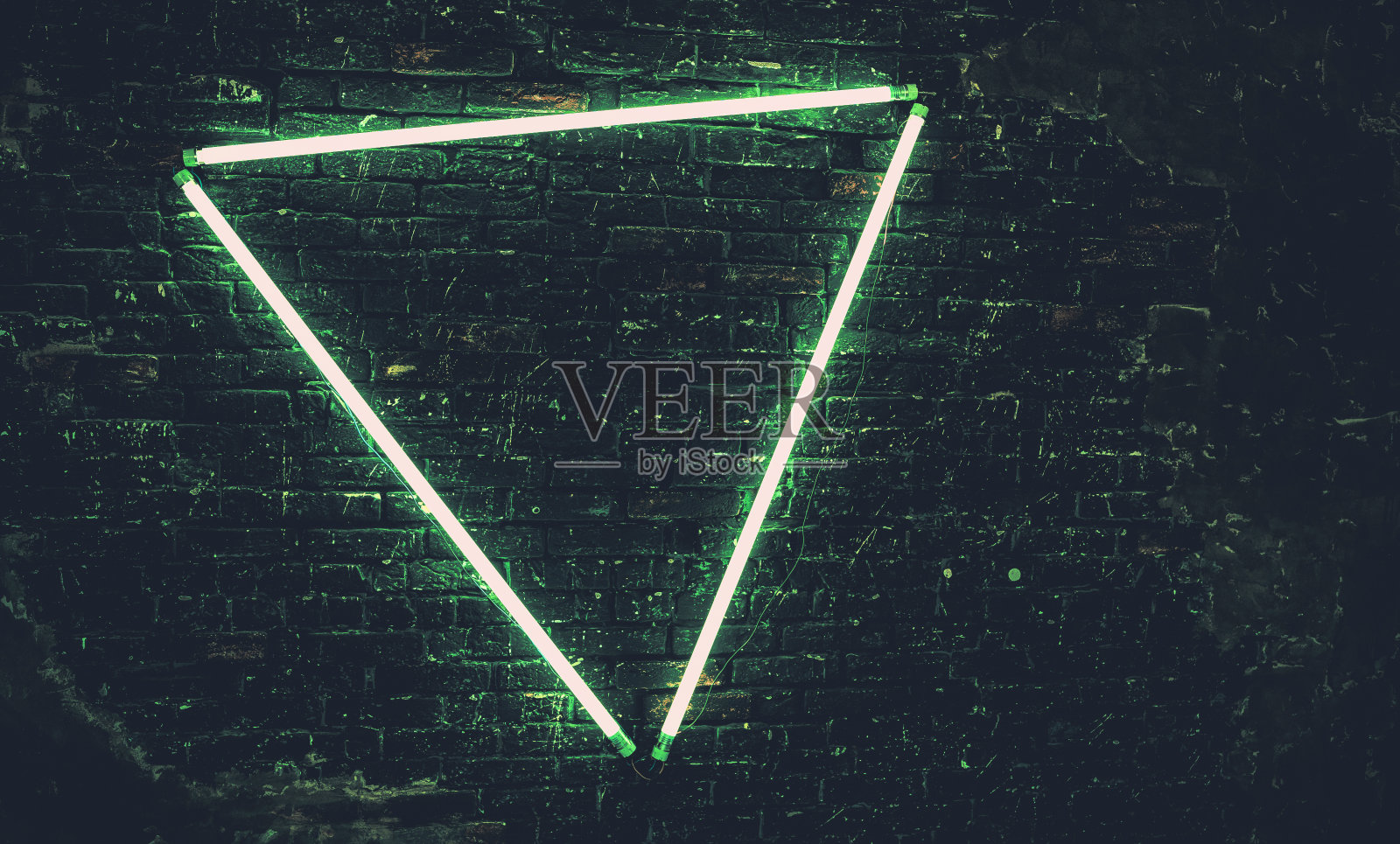 现代的砖墙内部以三角形的形式发光的灯。近距离的照明墙照片摄影图片