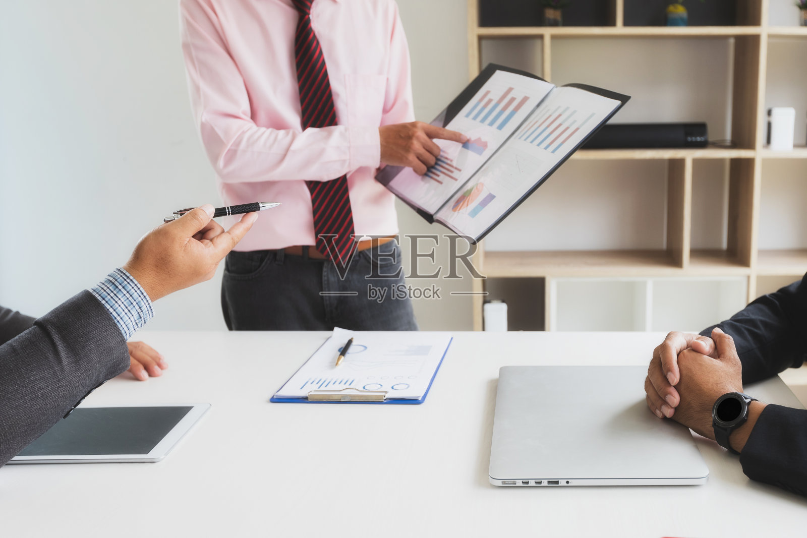 商人们在会议上向同事们提交收入报告，每月的大学预算，财务图表。照片摄影图片