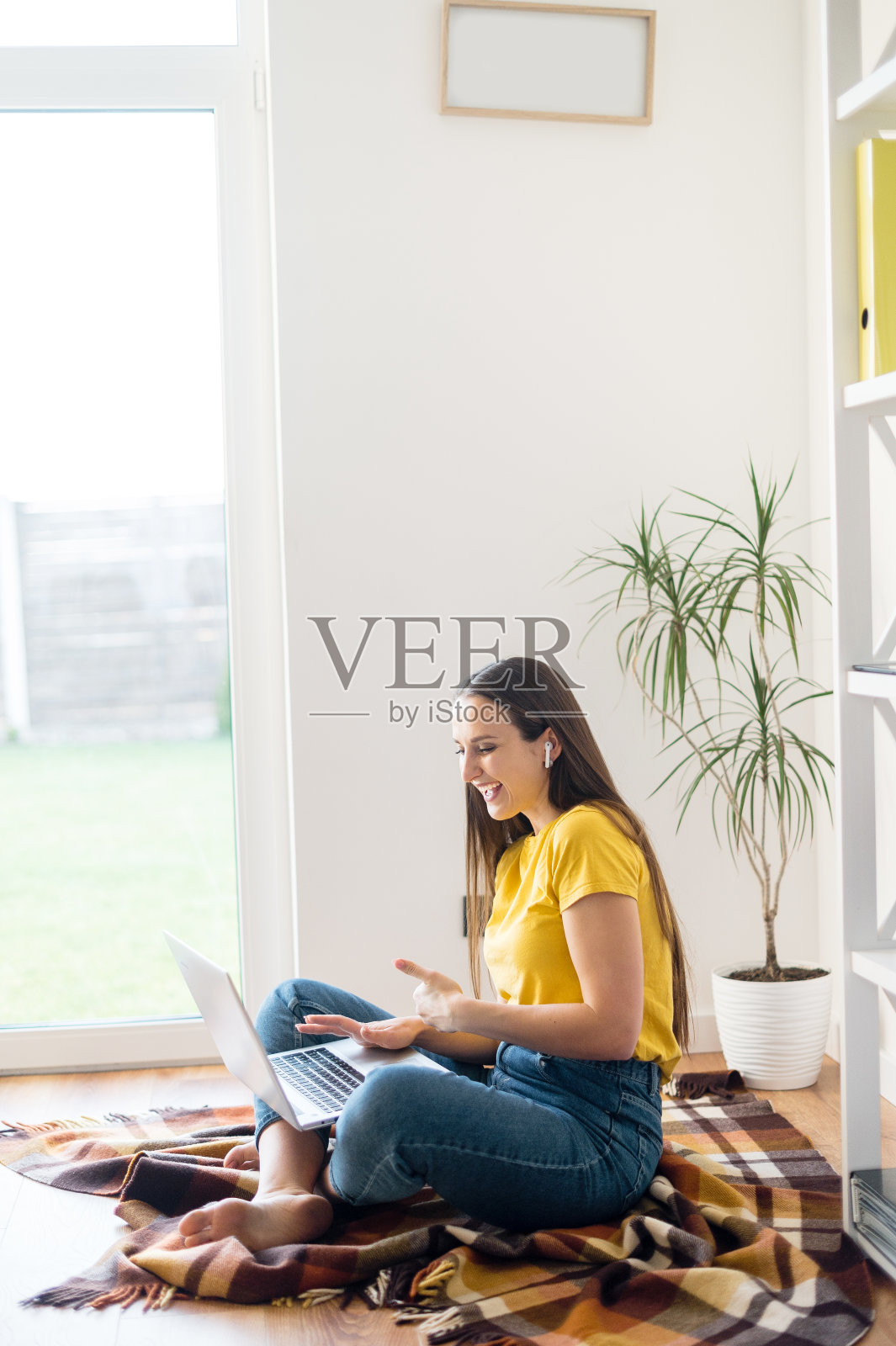 穿黄色T恤的女人通过视频交流照片摄影图片