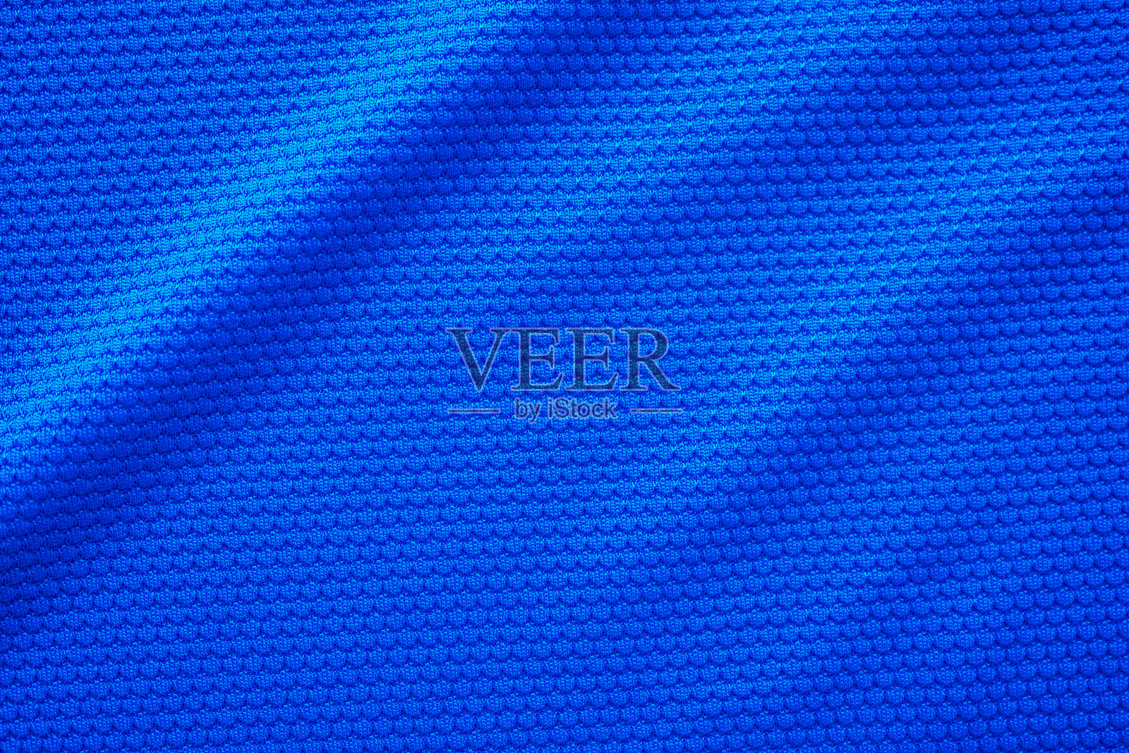 蓝色足球运动衫服装面料质地运动服背景，特写俯视图照片摄影图片