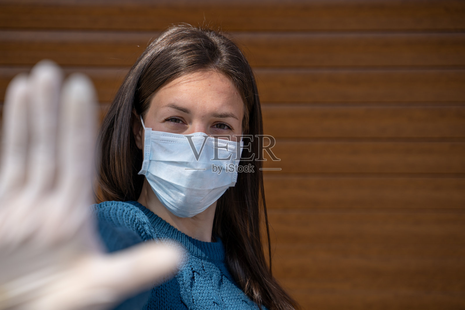 严肃的女人在外科口罩看着相机显示停止手势-股票照片照片摄影图片