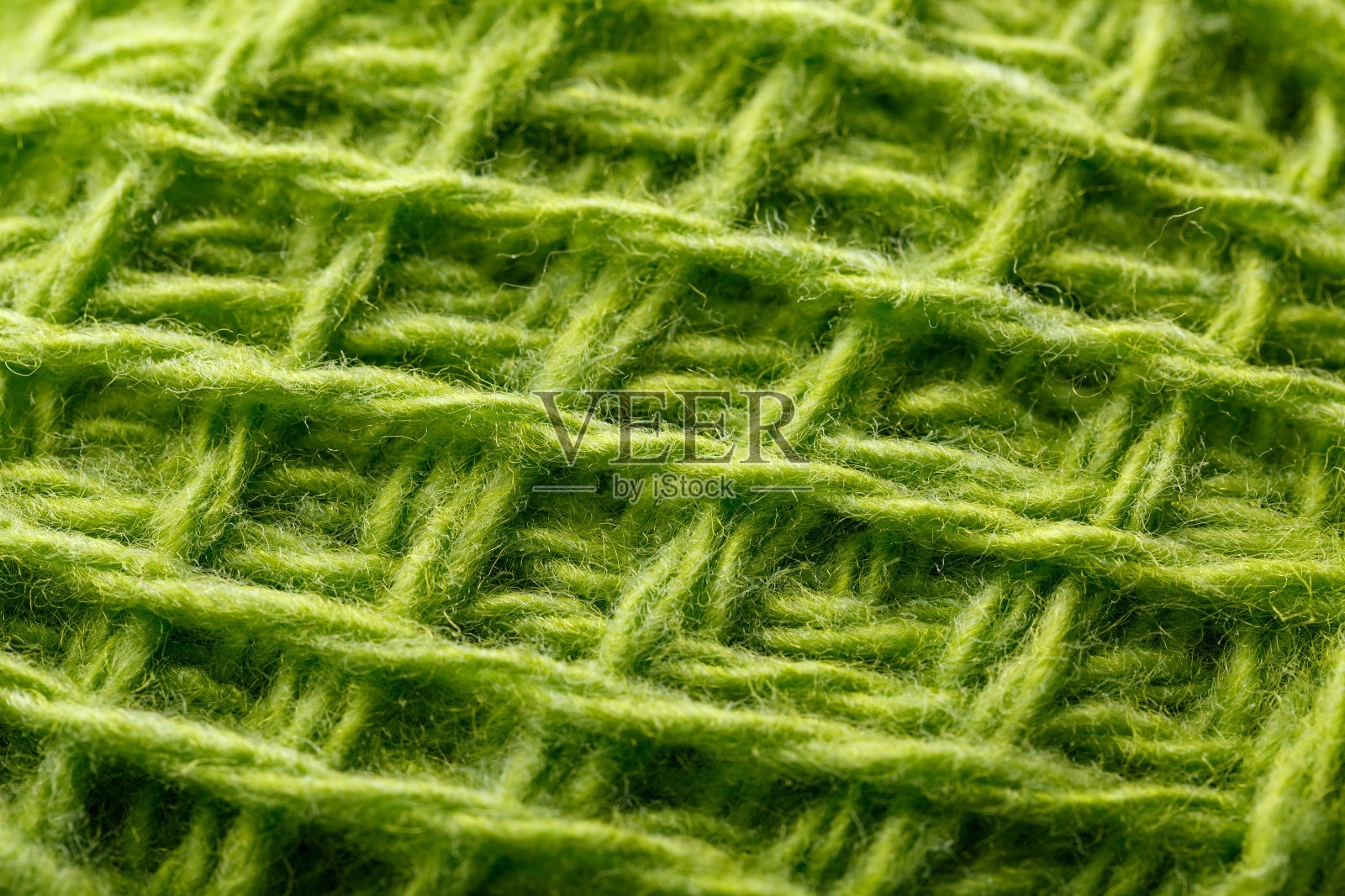 羊毛纱线闭合彩色的绿色线在宏观刺绣。照片摄影图片