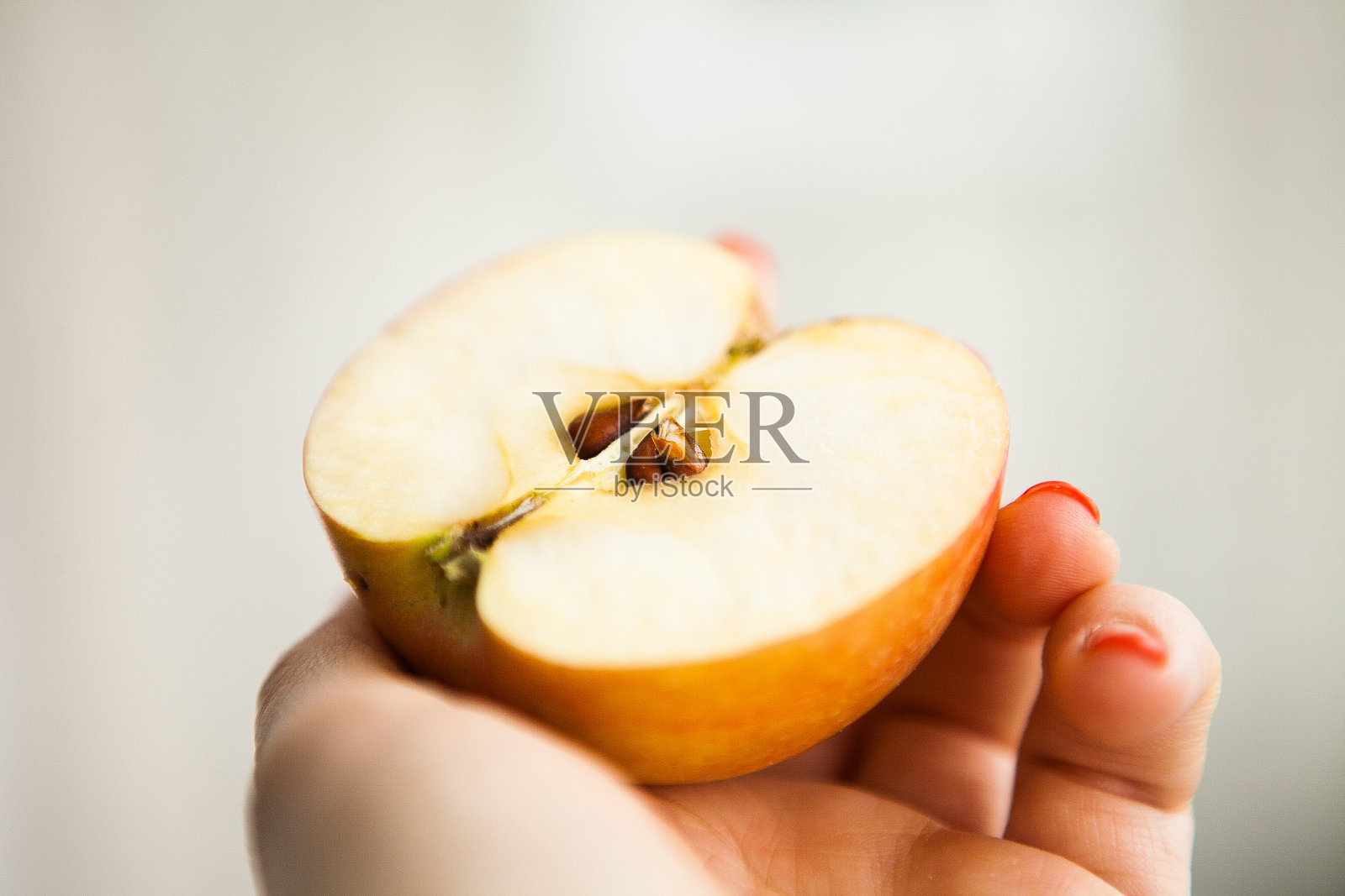 有人手里拿着半个苹果照片摄影图片